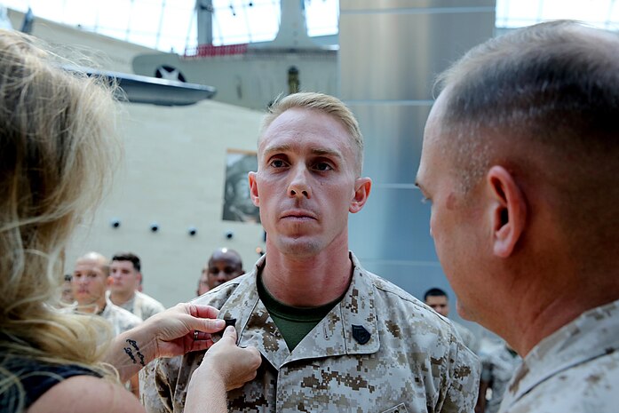 Justin R. Gates with Chemical Biological Incident Force, CBIRF, was pinned to the rank of gunnery sergeant by his wife and Col. Stephen E. Redifer during a promotion/reenlistment ceremony at the National Museum of the Marine Corps at Triangle, Va., Aug. 1, 2016. Gates works as a ground electrician system maintenance mechanic and runs the Marine Corps Martial Arts Program, MCMAP, for CBIRF. (Official USMC photo by Lance Cpl. Maverick Mejia)


