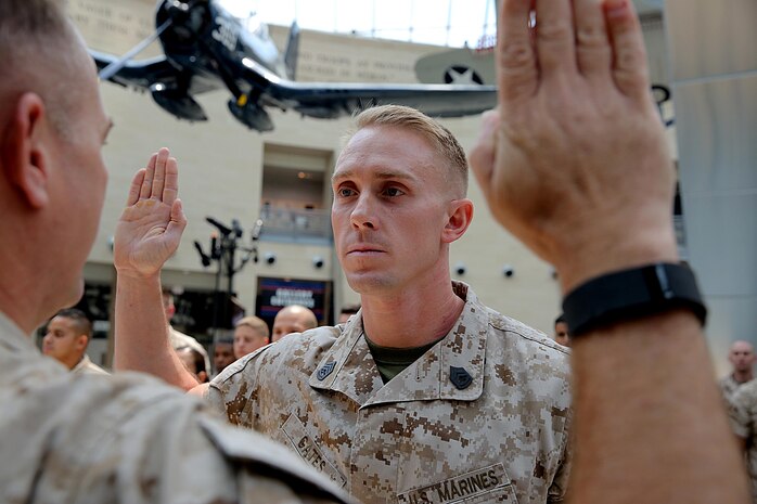 Justin R. Gates with Chemical Biological Incident Force, CBIRF, recites the reenlistment oath given by Col. Stephen E. Redifer during a promotion/ reenlistment ceremony at the National Museum of the Marine Corps, Triangle, Va., Aug. 1, 2016. Gates works as a ground electrician system maintenance mechanic and runs the Marine Corps Martial Arts Program, MCMAP, for CBIRF. (Official USMC photo by Lance Cpl. Maverick Mejia)
