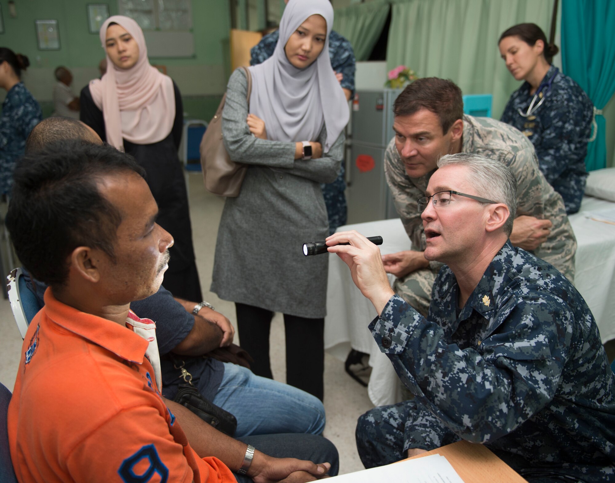 U.S. Navy Capt. Craig Salt (right), from Annapolis, Maryland, and U.S. Air Force Lt. Col. Jeff Healy, from Honolulu, both plastic surgeons assigned to USNS Mercy (T-AH 19), examine a patient during a Pacific Partnership 2016 surgical screening at the Kuantan Naval Base medical facility. This is the first time Pacific Partnership has visited Malaysia. Partner nations are working side-by-side with local organizations in a search-and-rescue exercise, civil engineering projects, community relation events and subject matter expert exchanges. (U.S. Navy photo by Mass Communication Specialist 2nd Class Lindsey E. Skelton/Released)
