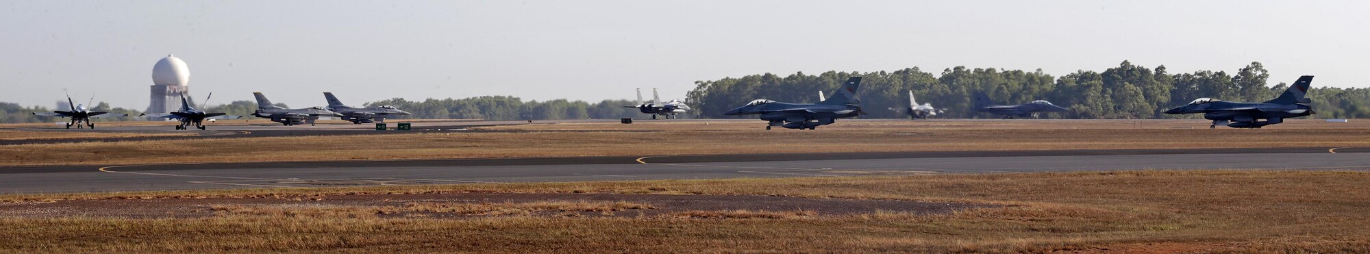 Royal Australian Air Force (RAAF) FA-18A Hornets, U.S. Air Force and Indonesian Air Force F-16s, and Republic of Singapore Air Force F-15s, prepare to take off for a morning sortie during Exercise Pitch Black, at RAAF Base Darwin, Australia, Aug. 2, 2016. Pitch Black is a biennial multinational air warfare exercise hosted by the RAAF that focuses on offensive counter air and defensive counter air combat in a simulated war environment. (Australian Defence Force photo by LSIS Jayson Tufrey)