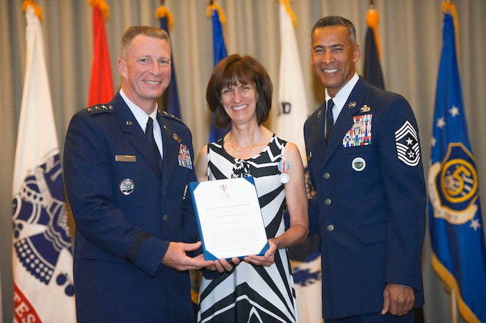 Nancy Dolan, wife of former United States Forces Japan Commander Lt. Gen. John Dolan, receives the Commander's Public Service Award for her contributions toward improving morale and quality of life for military families throughout Japan, Aug. 4, 2016. The award was presented at the ceremony marking General Dolan's relinquishment of command. (U.S. Air Force photo by Senior Airman Delano Scott)
