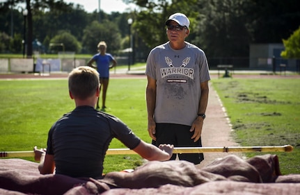 Pole vault Coach Tom Reagan, gives Andrew Bronson, son of 628th Air Base Wing Command Chief Master Sgt. Mark A. Bronson, feedback on his performance at the Park West Recreation Center in Mt. Pleasant, S.C., July 20, 2016. Bronson was preparing to compete in the USA Track and Field National Junior Olympics which took place in Sacramento, Calif., July 25-31 2016. (U.S. Air Force photo by Staff Sgt. Marianique Santos/Released)
