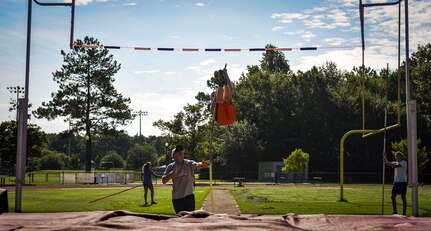 Andrew Bronson, 14, son of 628th Air Base Wing Command Chief Master Sgt. Mark A. Bronson, launches himself into the air during pole vaulting practice at the Park West Recreation Center in Mt. Pleasant, S.C., July 20, 2016. Bronson practiced prior to competing in the USA Track and Field National Junior Olympics which took place in Sacramento, Calif., July 25-31, 2016. (U.S. Air Force photo by Staff Sgt. Marianique Santos/Released)