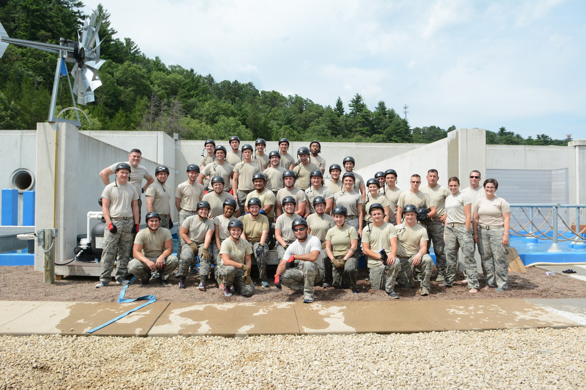 Thirty-three Airmen and their first sergeants pose in front of one of the Leadership Development Course water obstacles at the Volk Field Air National Guard Base, Camp Douglas, Wis., July 27, 2016. Airmen traveled from across the state of Wisconsin to participate in the Junior Enlisted Orientation Program held throughout the state July 26-28.