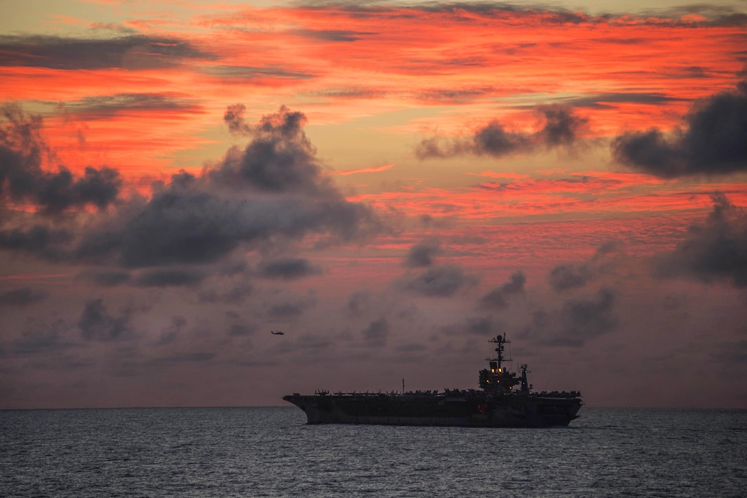 The aircraft carrier USS John C. Stennis conducts helicopter operations at sunset during Rim of the Pacific 2016, a maritime exercise, in the Pacific Ocean, July 31, 2016. Twenty-six nations and 25,000 personnel participated in the exercise, which provided training to help ensure security on the world's oceans. Navy photo by Petty Officer 1st Class Jason Noble