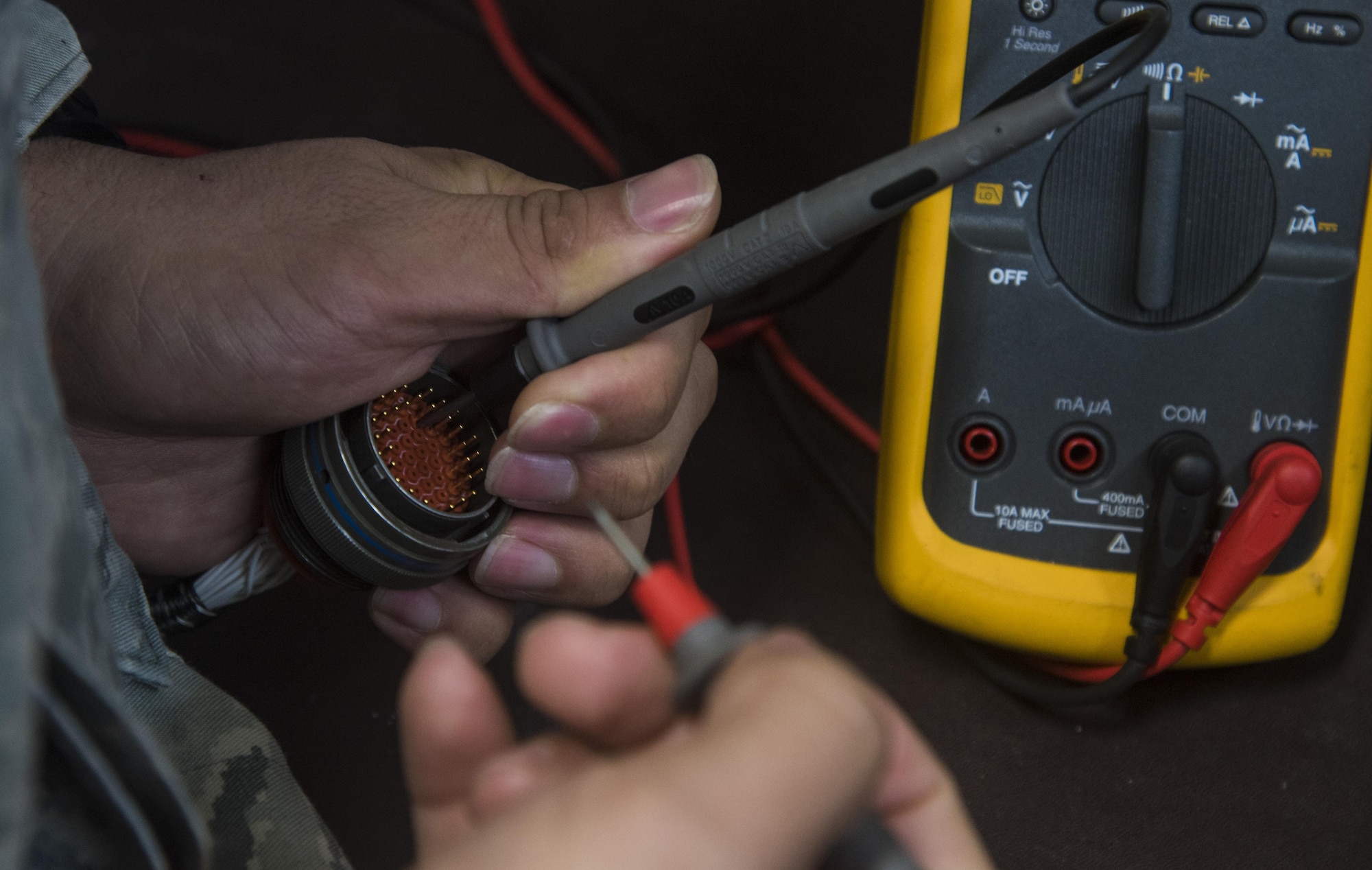 U.S. Air Force Staff Sgt. Felipe Rosario, the team lead of the 35th Maintenance Squadron avionics intermediate section electronic warfare section, demonstrates how troubleshooting line replaceable units was done prior to the creation of a breakout box and line replaceable unit extension cables at Misawa Air Base, Japan, Aug. 1, 2016. Airmen from the avionics flight recently developed a breakout box and cables to connect to the LRUs instead of doing it manually, making the process more efficient. (U.S. Air Force photo by Senior Airman Jordyn Fetter)
