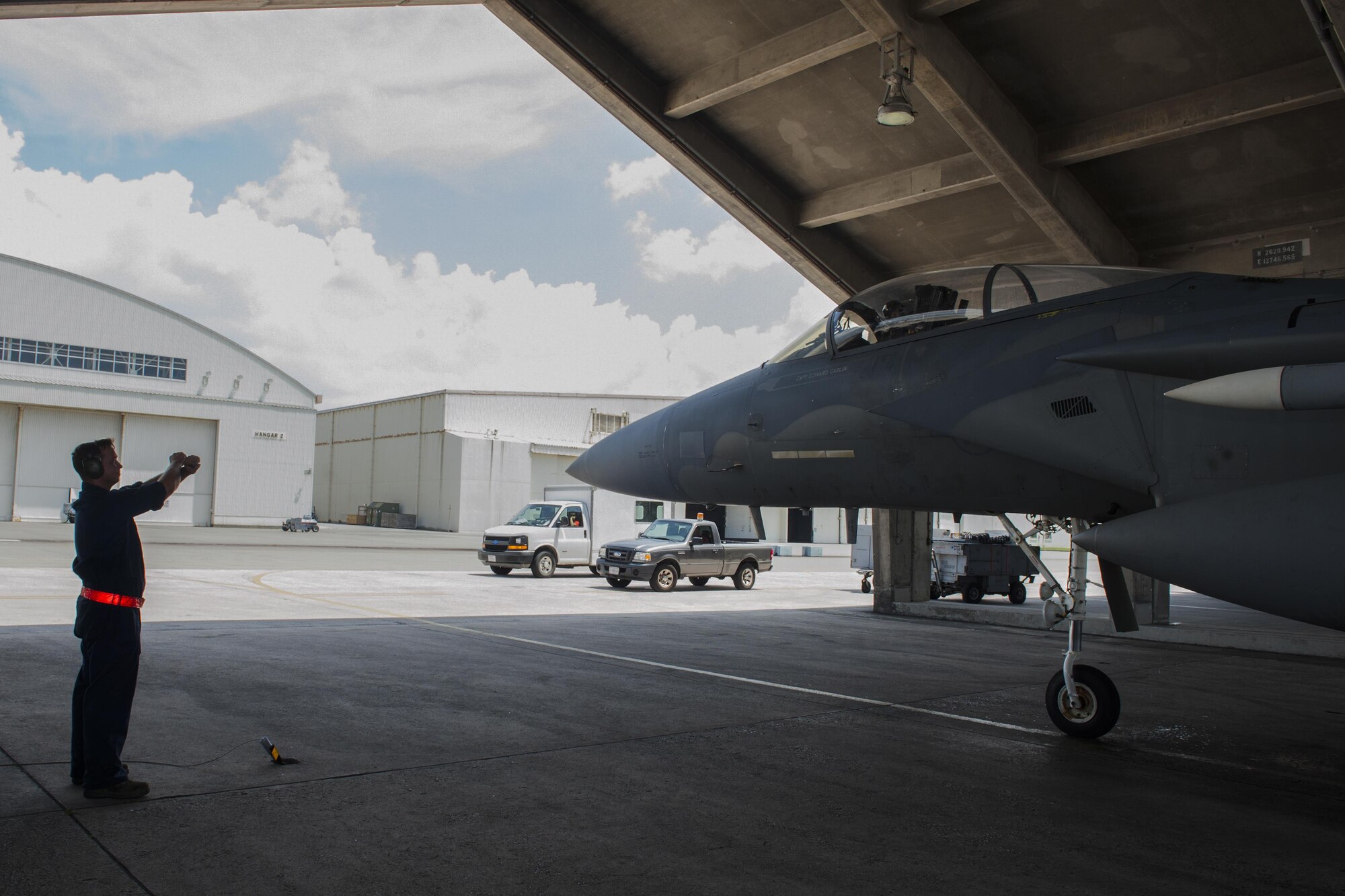 U.S. Air Force Airman 1st Class Marc Hicks, 18th Aircraft Maintenance Squadron crew chief, guides an F-15 Eagle July 29, 2016, at Kadena Air Base, Japan. The Eagle was piloted by Lt. Col. James McFarland, 67th Fighter Squadron commander, when it reached its 10,000 flight hours mark. This flight was also McFarland’s final flight as the commander. (U.S. Air Force photo by Airman 1st Class Lynette M. Rolen)