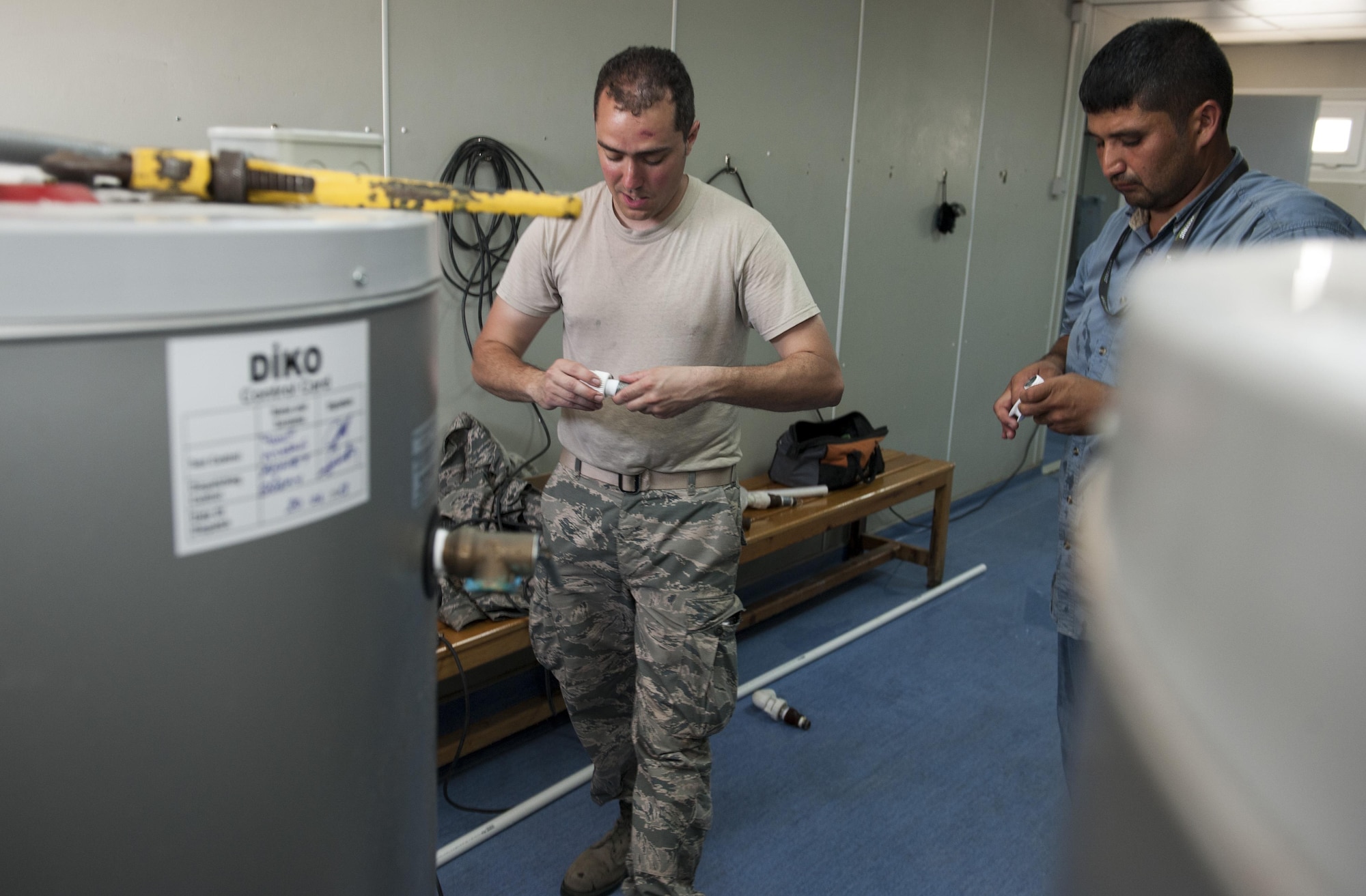 U.S. Air Force Staff Sgt. Ryan Bombardiere, 48th Civil Engineer Squadron (CES) water fuels system maintenance technician, and Ahmet Karsli 39th CES, fit pipeing together for use in repairs to a water heater July 28, 2016, at Incirlik Air Base, Turkey. Water heater units store and heat water for use throughout facilities for showers, sinks washers and other devices. CES servicemembers from across   U.S. Air Forces in Europe-Air Forces Africa integrated with members from the 39th CES to support the ongoing 39th Air Base Wing missions after the July 15, 2016, failed Turkish military coup. (U.S. Air Force photo by Staff Sgt. Jack Sanders)