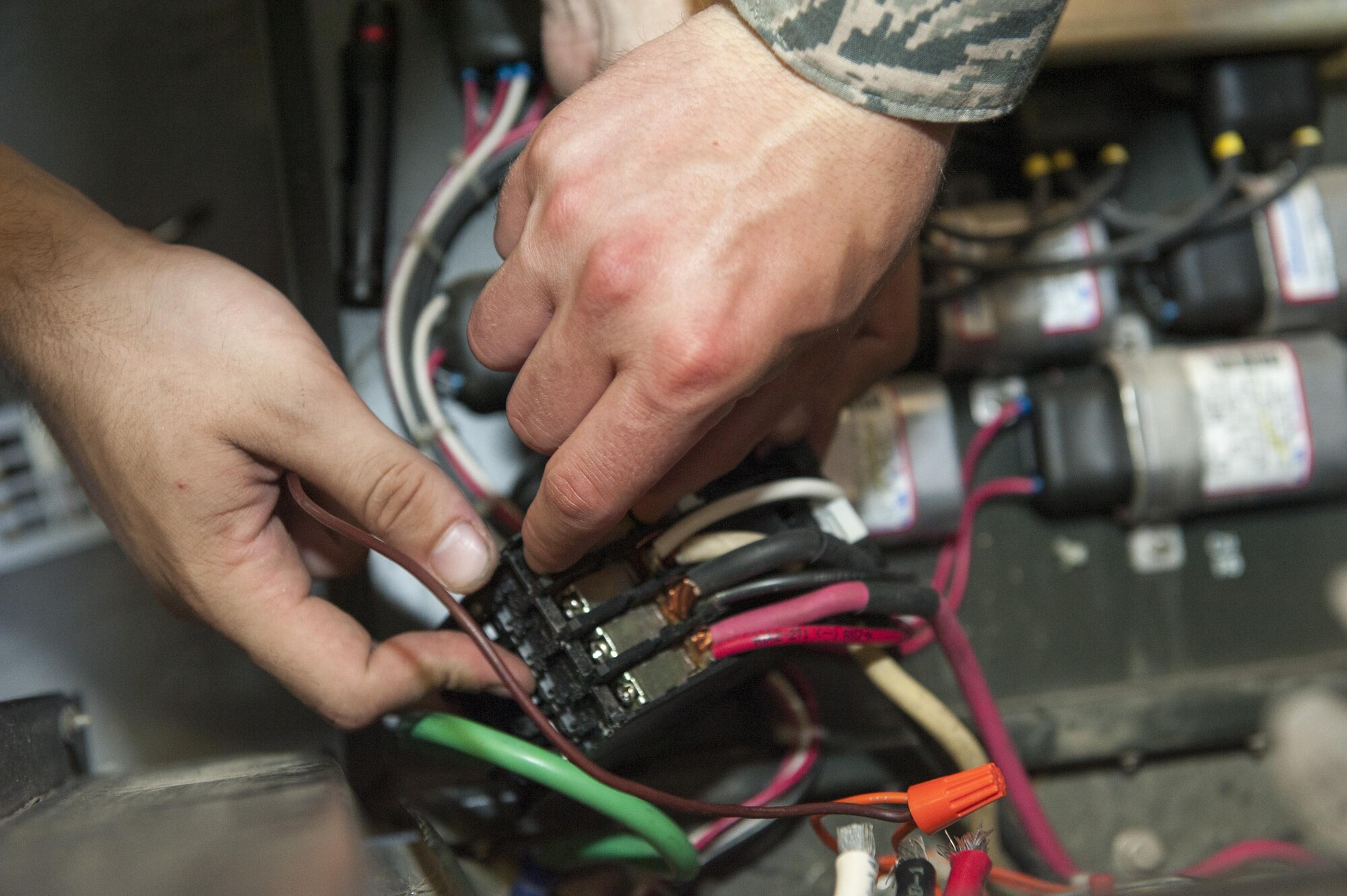 U.S. Air Force Senior Airman Todd Gonsalves, 786th Civil Engineer Squadron heating, ventilation and air conditioning journeyman, connects components of an air conditioning unit together during a repair July 28, 2016, at Incirlik Air Base, Turkey. Because of their continuous use during summer months, HVAC repair technicians must perform maintenance and repairs regularly. (U.S. Air Force photo by Staff Sgt. Jack Sanders)