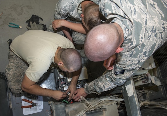 U.S. Air Force Airmen from across U.S. Air Forces in Europe-Air Forces Africa heating ventilation and air conditioning (HVAC) repair section work on an air conditioning unit July 28, 2016, at Incirlik Air Base, Turkey. Airmen arrived at Incirlik to augment and support forces here in continuing operations supporting the 39th Air Base Wing. (U.S. Air Force photo by Staff Sgt. Jack Sanders)