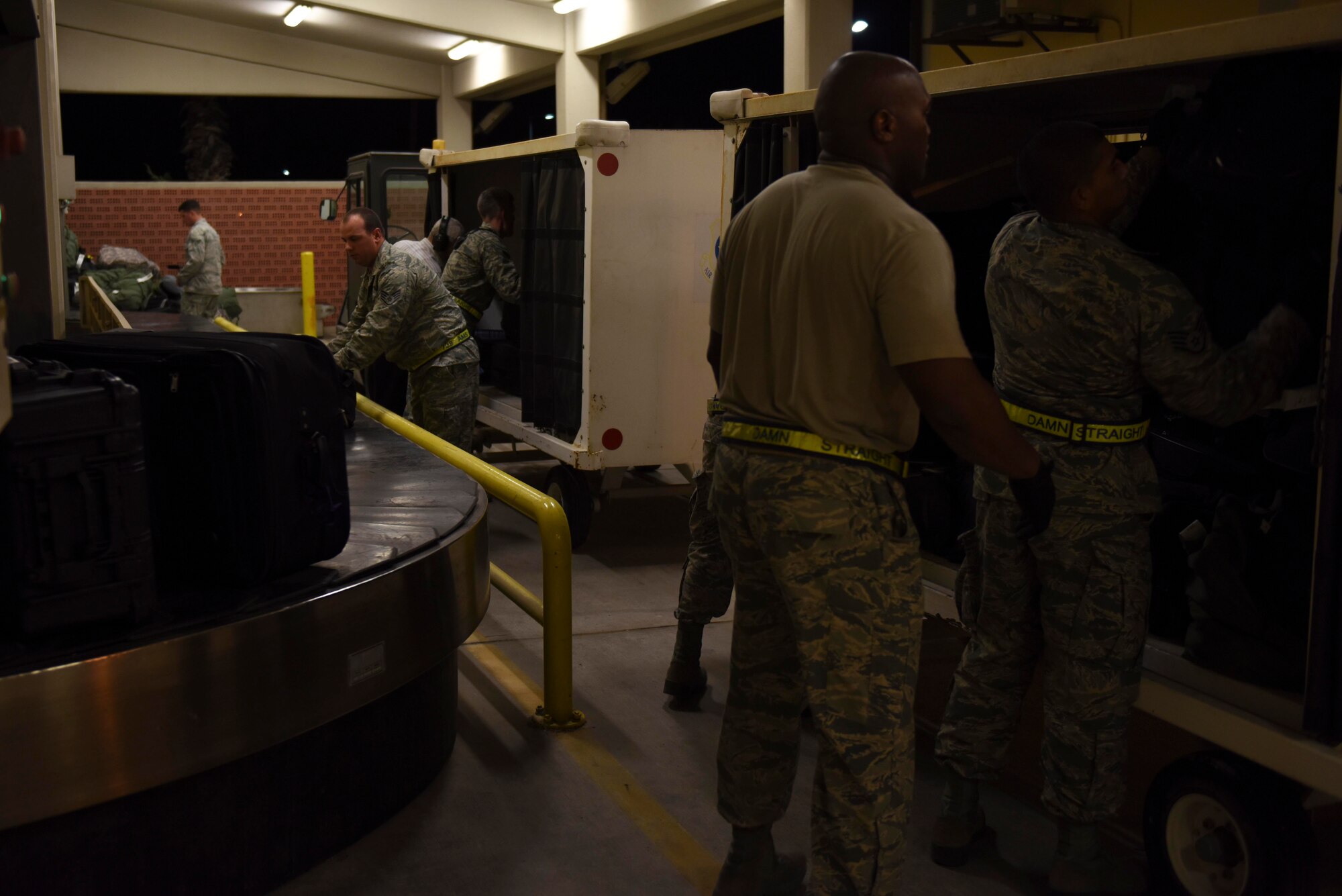 U.S. Air Force Airmen assigned to the 728th Air Mobility Squadron, unload a baggage cart July 13, 2016, at Incirlik Air Base, Turkey. Freight Airmen are responsible for loading and unloading aircraft that fly into Incirlik. (U.S. Air Force photo by Airman 1st Class Devin M. Rumbaugh)