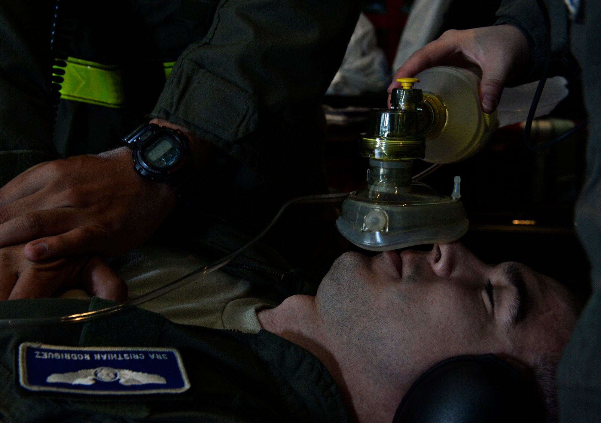 Senior Airman Cristhian Rodriguez, 86th Aeromedical Evacuation Squadron aeromedical evacuation technician, simulates a patient receiving a bag valve mask during a training mission at Ramstein Air Base, Germany, July 21, 2016. In addition to providing medical care while transporting patients, AE technicians are responsible for assisting patients during aircraft emergencies.  (U.S. Air Force photo/ Senior Airman Nesha Humes)