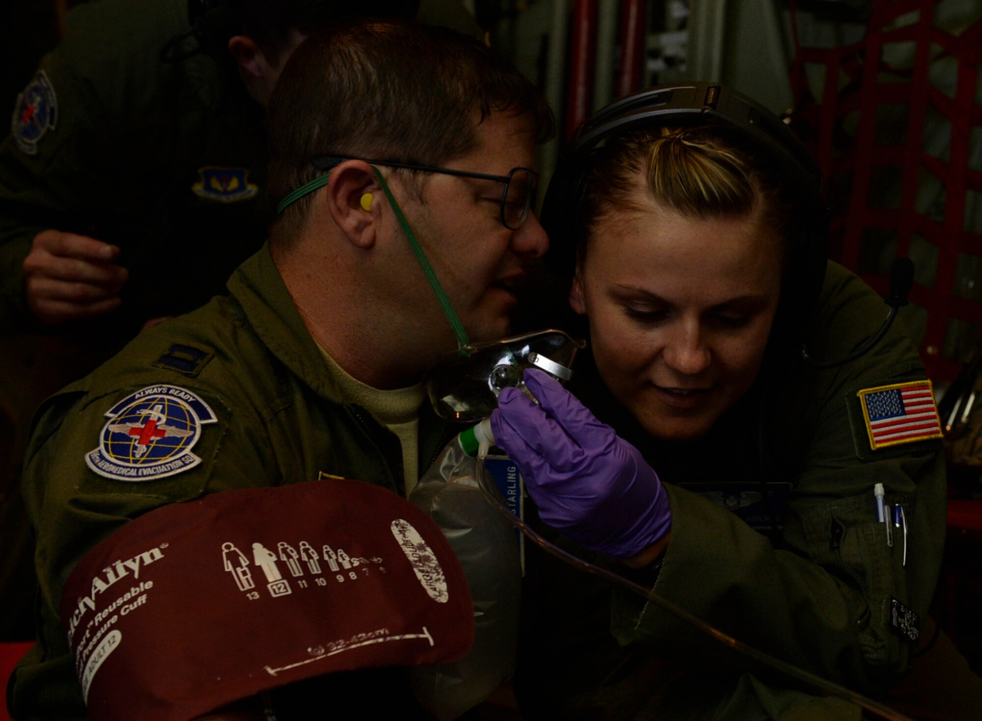 Capt. Daniel Starling, 86th Aeromedical Evacuation Squadron flight nurse, plays the role of a patient while speaking to Staff Sgt. Kaylee Jimenez, 86th AES aeromedical evacuation technician, during a training mission at Ramstein Air Base, Germany, July 21, 2016. Technicians must maintain a close distance to effectively communicate with patients over the C-130J Super Hercules’ engine noise. (U.S. Air Force photo/ Senior Airman Nesha Humes)