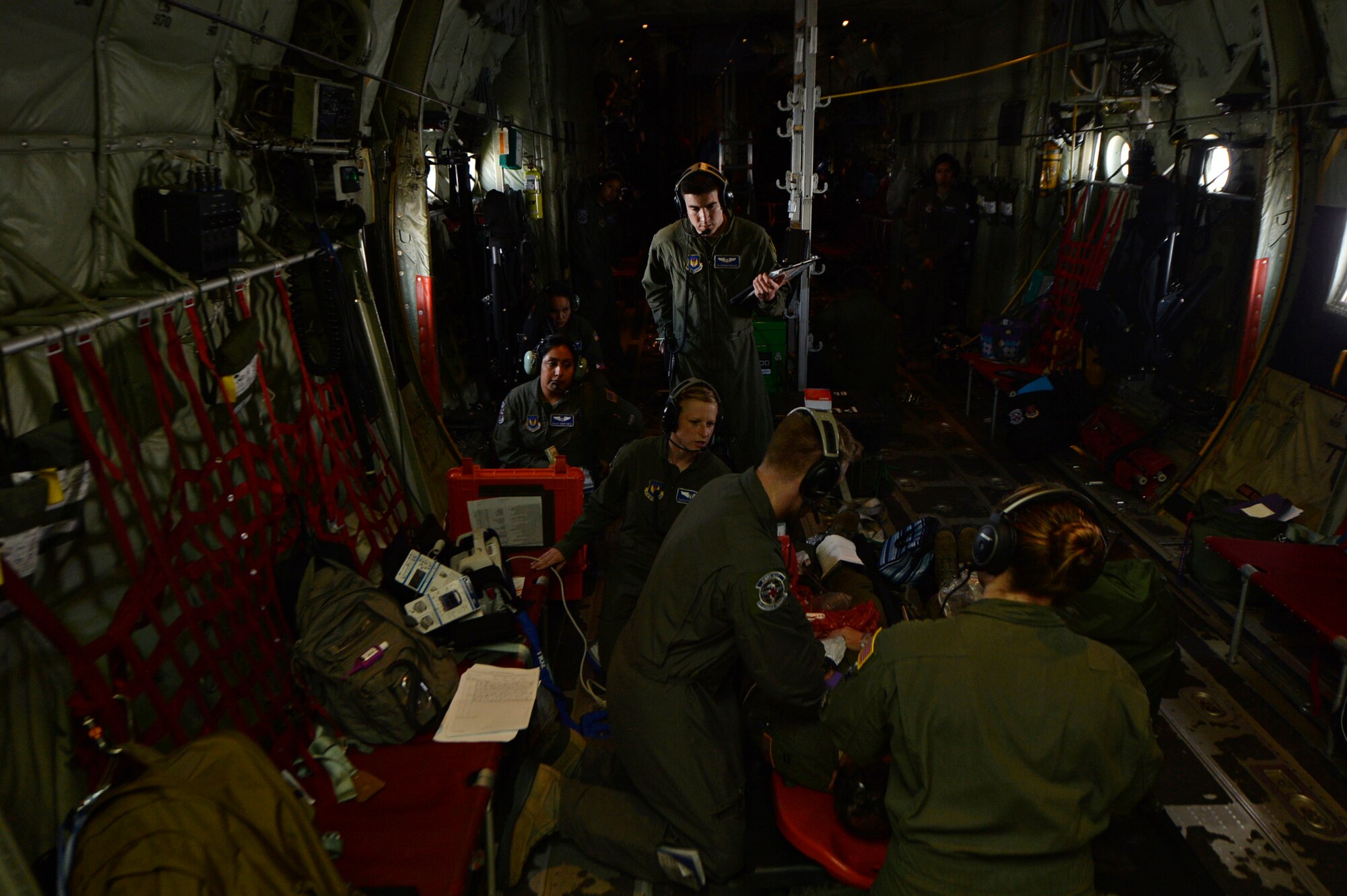 Airmen from the 86th Aeromedical Evacuation Squadron  assess a mock patient during a training mission at Ramstein Air Base, Germany, July 21, 2016. There are currently four U.S. Air Force active-duty AESs, which make up 29 percent of the total aeromedical evacuation capability. (U.S. Air Force photo/ Senior Airman Nesha Humes)