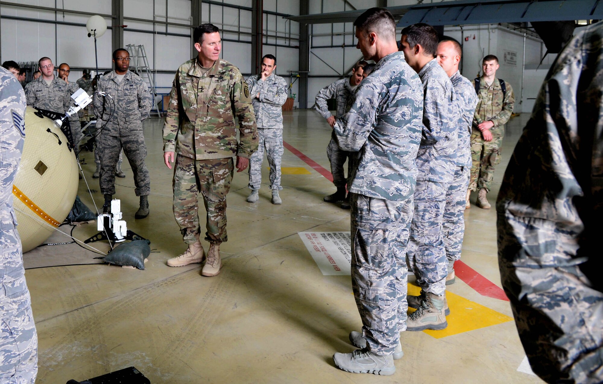 U.S. Army Maj. Gen. Mark C. Schwartz, commander of the Special Operations Command-Europe, meets Airmen during a tour Aug. 1, 2016, on RAF Mildenhall, England. The visit consisted of briefings, tours and demonstrations from various units assigned to the 352nd Special Operations Wing. (U.S. Air Force photo by Airman 1st Class Tenley Long)