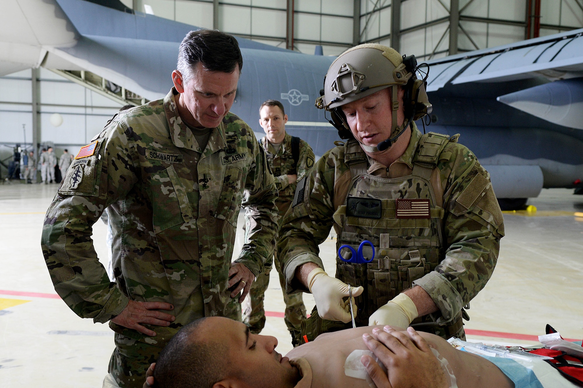 U.S. Army Maj. Gen. Mark C. Schwartz, left, commander of the Special Operations Command-Europe, watches Airmen demonstrate medical procedures during a tour Aug. 1, 2016, on RAF Mildenhall, England. The demonstration was one of many displays presented during the visit. (U.S. Air Force photo by Airman 1st Class Tenley Long)