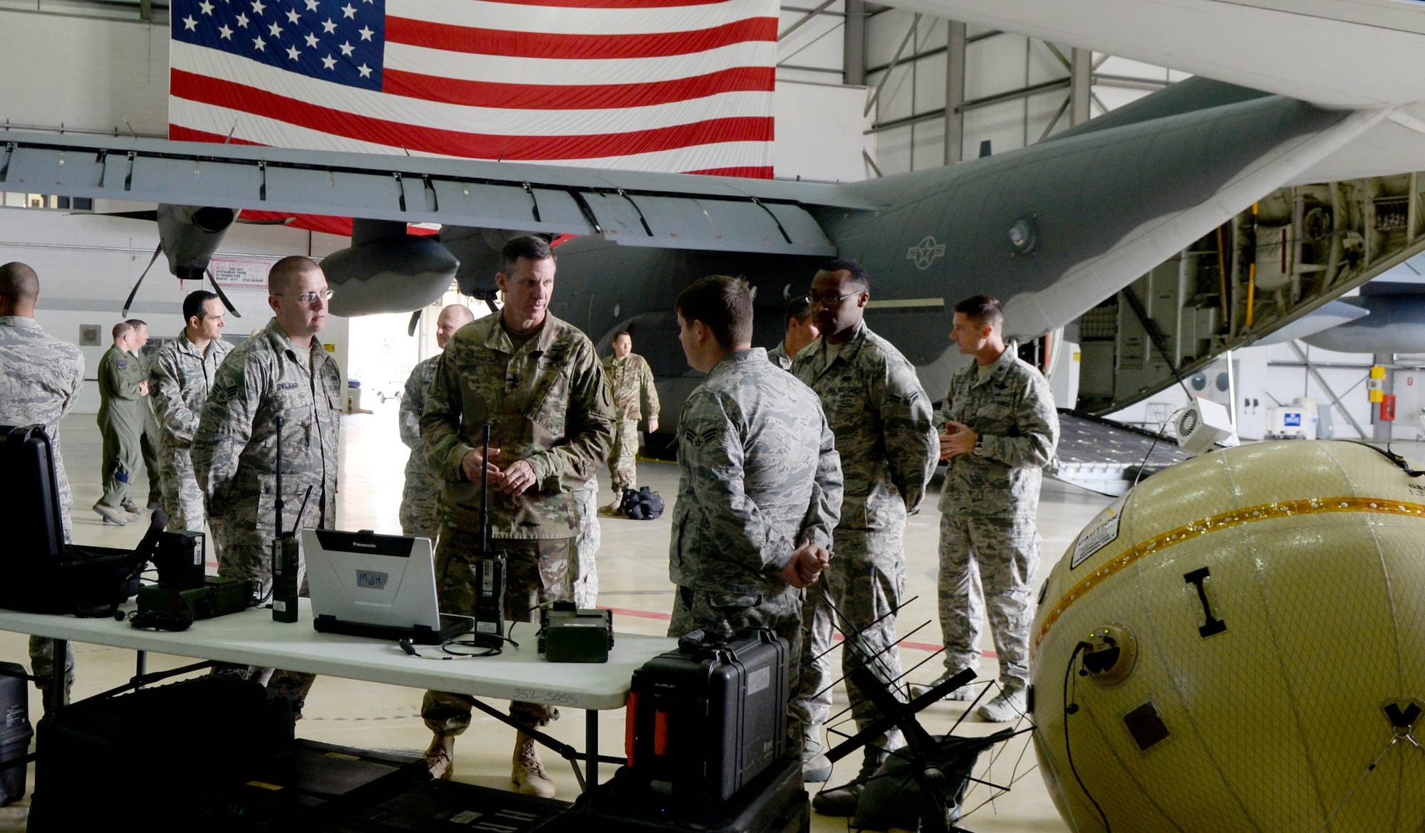 U.S. Army Maj. Gen. Mark C. Schwartz, center, commander of the Special Operations Command-Europe, talks with Airmen from the 352nd Special Operations Wing during his visit Aug. 1, 2016, on RAF Mildenhall, England. The Airmen explained their role within the 352nd SOW and presented some of the equipment they use. (U.S. Air Force photo by Airman 1st Class Tenley Long)