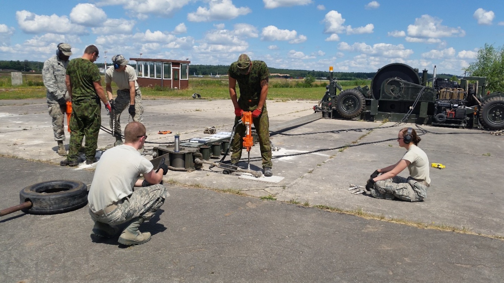 Airmen from the 435th Construction and Training Squadron and Lithuanian air force participate in a training exercise with a Mobile Aircraft Arresting System July 20, 2016, at Ramstein Air Base, Germany. These training opportunities not only serve to educate U.S. Air Force partners and provide them with world-class training, but also serve to bring the U.S. and its allies together at the lowest levels to form relationships and learn from each other. (U.S. Air Force courtesy photo)