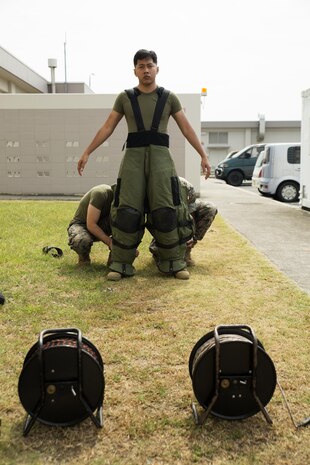 U.S. Marine Corps Sgt. Samnang Chang, a Marine security guard with the Marine Corps Embassy Security Group at the U.S. Embassy in Tokyo, Japan, is dressed with an EOD-9 Advanced Bomb Suit before performing the bomb suit agility test during his EOD technician screening process outside the EOD building at Marine Corps Air Station Iwakuni, Aug. 2, 2016. The bomb suit agility test evaluates the Marine’s ability to stay calm and perform physical, mental and memorization exercises in the heavy and claustrophobic environment of the EOD-9 ABS. (U.S. Marine Corps photo by Lance Cpl. Donato Maffin)  
