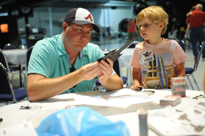Patrick Topp and four-year-old Colin, assemble a model SR-71 at a Blackbird Day symposium at the Museum of Aviation July30, celebrating the 40th anniversary of the world absolute speed record. (U.S. Air Force photo by Tommie Horton)