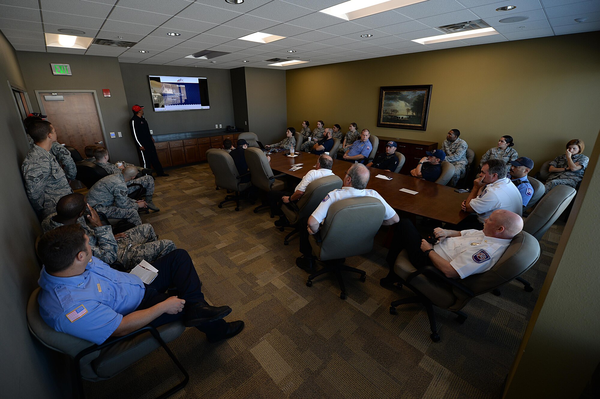 Airmen from both the 82nd Civil Engineer Squadron fire department and 82nd Medical Group, listen to Chris Whitmus, an Air Evac Lifeteam 34 pilot, give a medical air evacuation training session at Sheppard Air Force Base, Texas, Aug. 3, 2016. Whitmus trained more than 25 Airmen how to properly set up and navigate a landing zone during an emergency. (U.S. Air Force photo by Senior Airman Kyle E. Gese/Released)
