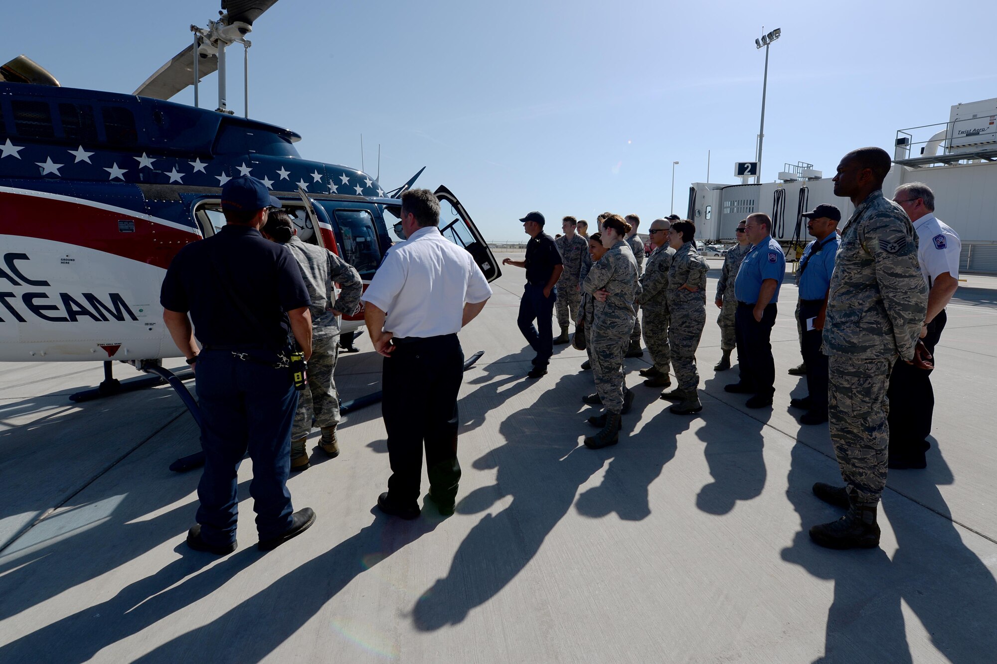 Airmen from both the 82nd Civil Engineer Squadron fire department and 82nd Medical Group, gather around the Air Evac Lifeteam 34 helicopter for a familiarization tour at Sheppard Air Force Base, Texas, Aug. 3, 2016. Chris Whitmus, an Air Evac Lifeteam 34 pilot, give a medical air evacuation training session to more than 25 Airmen showing them how to properly set up and navigate a landing zone during an emergency. (U.S. Air Force photo by Senior Airman Kyle E. Gese/Released)