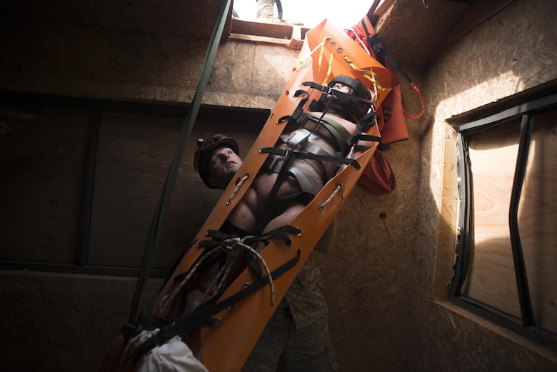 Senior Airman Aaron Strande, a search and rescue medic with the Massachusetts Air National Guard’s 102nd Intelligence Wing, stabilizes a sked for a vertical extraction during Vigilant Guard 2016 at Camp Ethan Allen Training Site, Vt., July 31, 2016. Vigilant Guard is a national-level emergency response exercise that provides National Guard units an opportunity to improve cooperation and relationships with regional civilian, military and federal partners in preparation for emergencies and catastrophic events. (U.S. Air National Guard photo/Airman 1st Class Jeffrey Tatro)