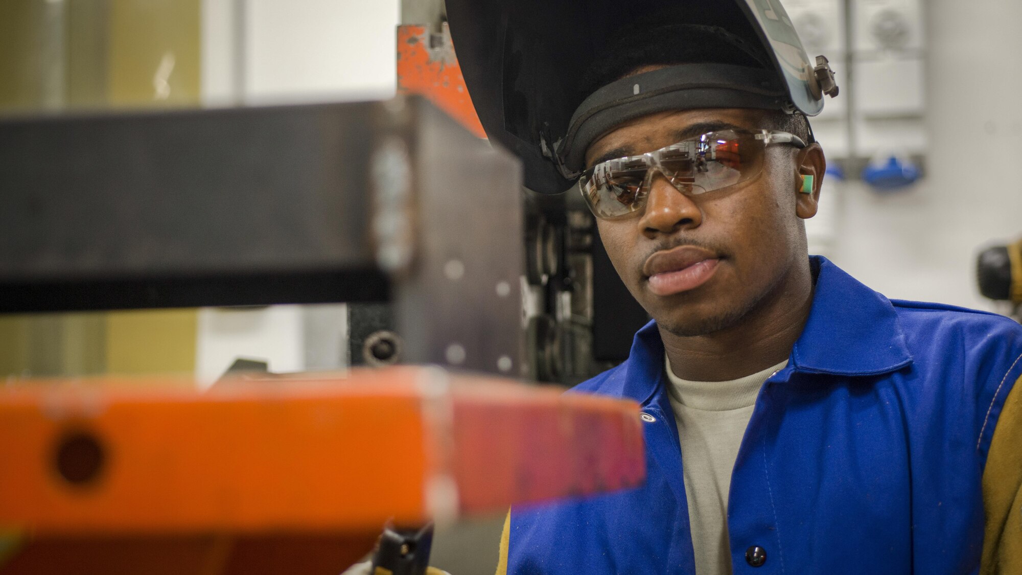 Senior Airman Jeffrey Jenkins, 31st Maintenance Squadron metals technology craftsman, examines a weld on a bracket for the 606th Air Control Squadron, Aug. 2, 2016, at Aviano Air Base, Italy. The metals technology Airmen weld, fabricate and create custom builds for F-16 Fighting Falcons assigned to the 31st Fighter Wing. (U.S. Air Force photo by Airman 1st Class Cory W. Bush/Released)