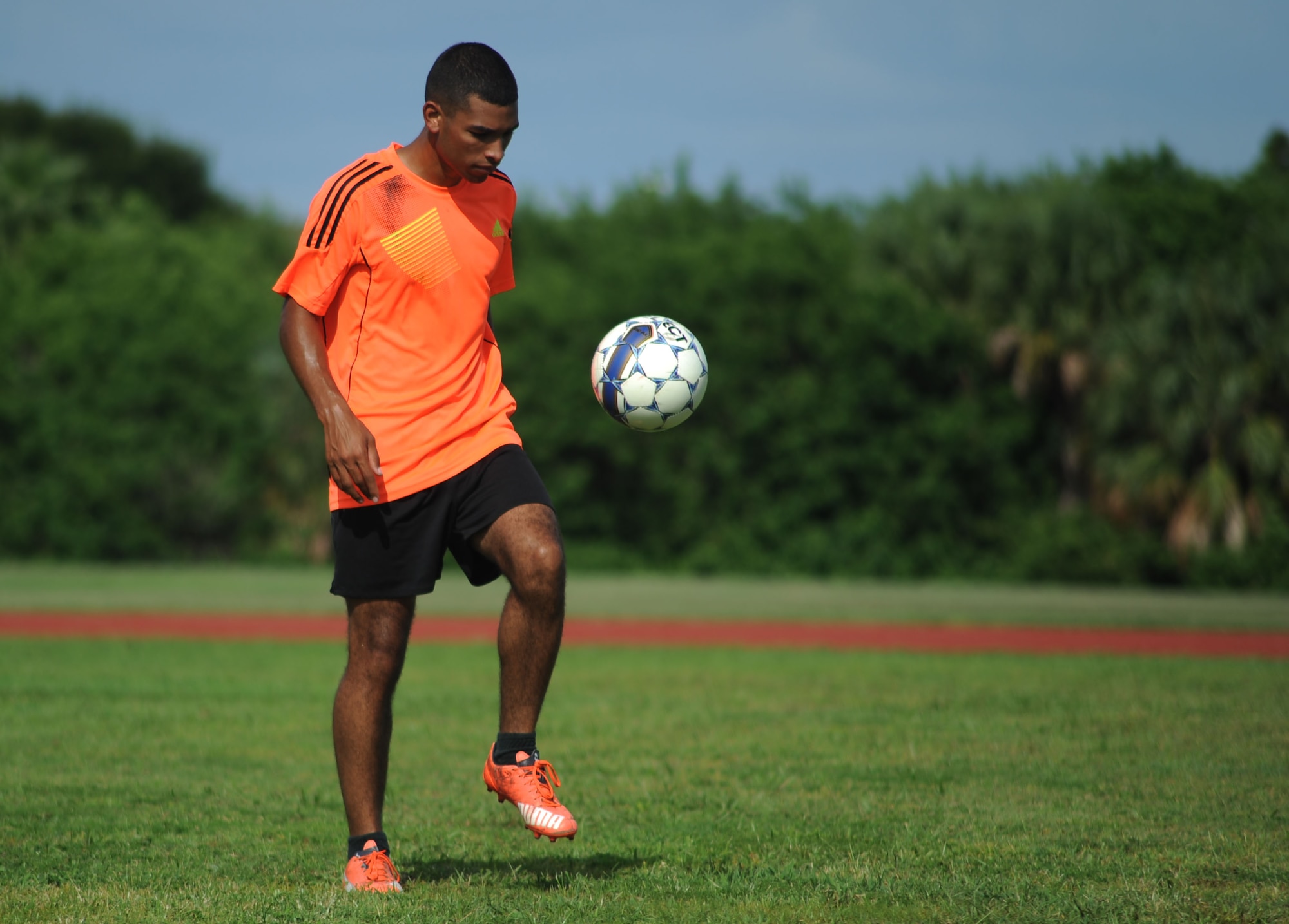 Senior Airman Geovanni Lee, a Milstar technician assigned to the 6th Communications Squadron, juggles a soccer ball during a practice session at MacDill Air Force Base, Fla., August 3, 2016. Lee is one of the captains of the MacDill Football Club, a local soccer team competing in an upcoming national military tournament. (U.S. Air Force photo by Airman Adam R. Shanks)