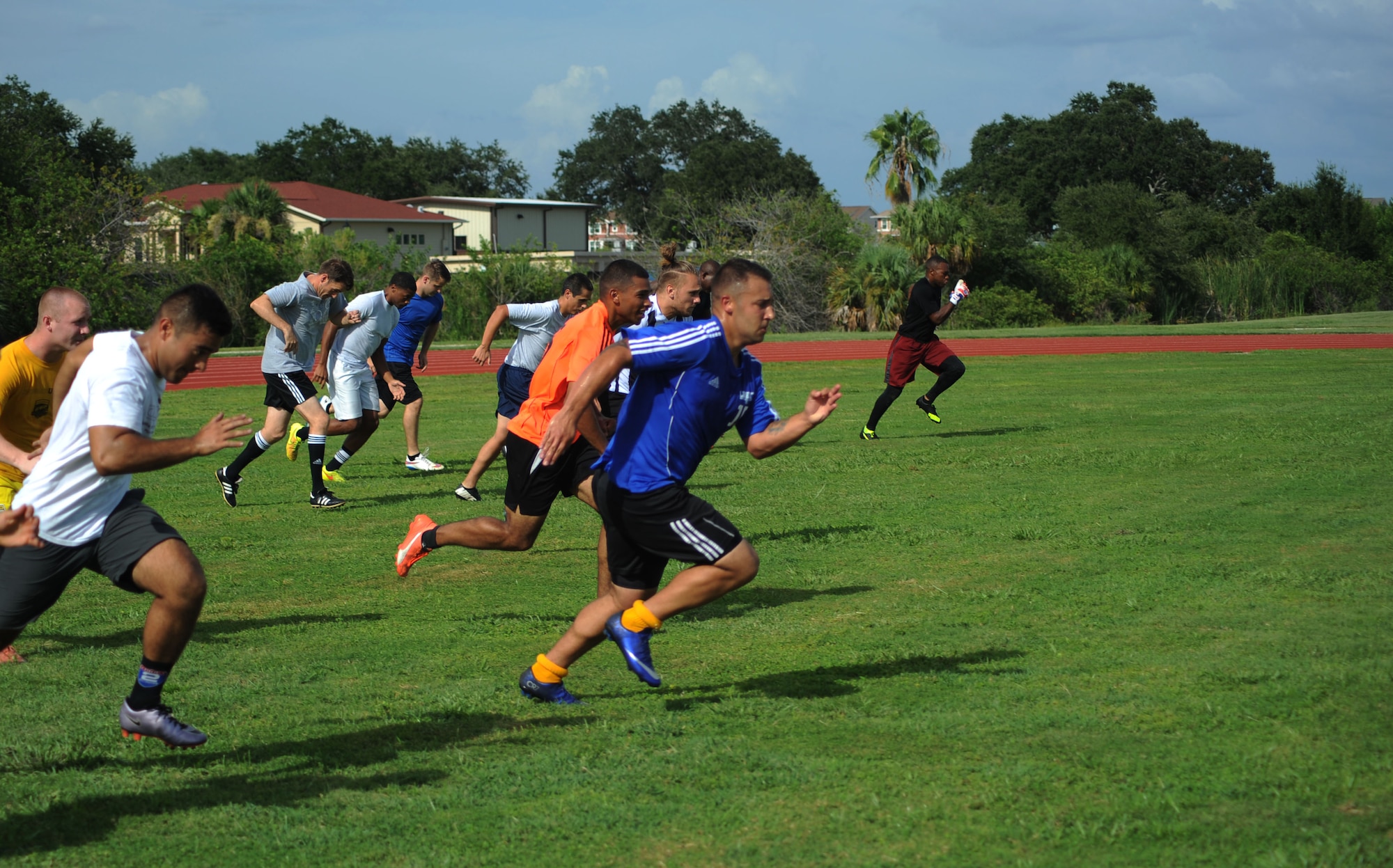 Members of MacDill Football Club, run sprints during team training at MacDill Air Force Base, Fla., August 3, 2016. Practice begins with warm-up runs and sprints to condition the team members. (U.S. Air Force photo by Airman Adam R. Shanks)