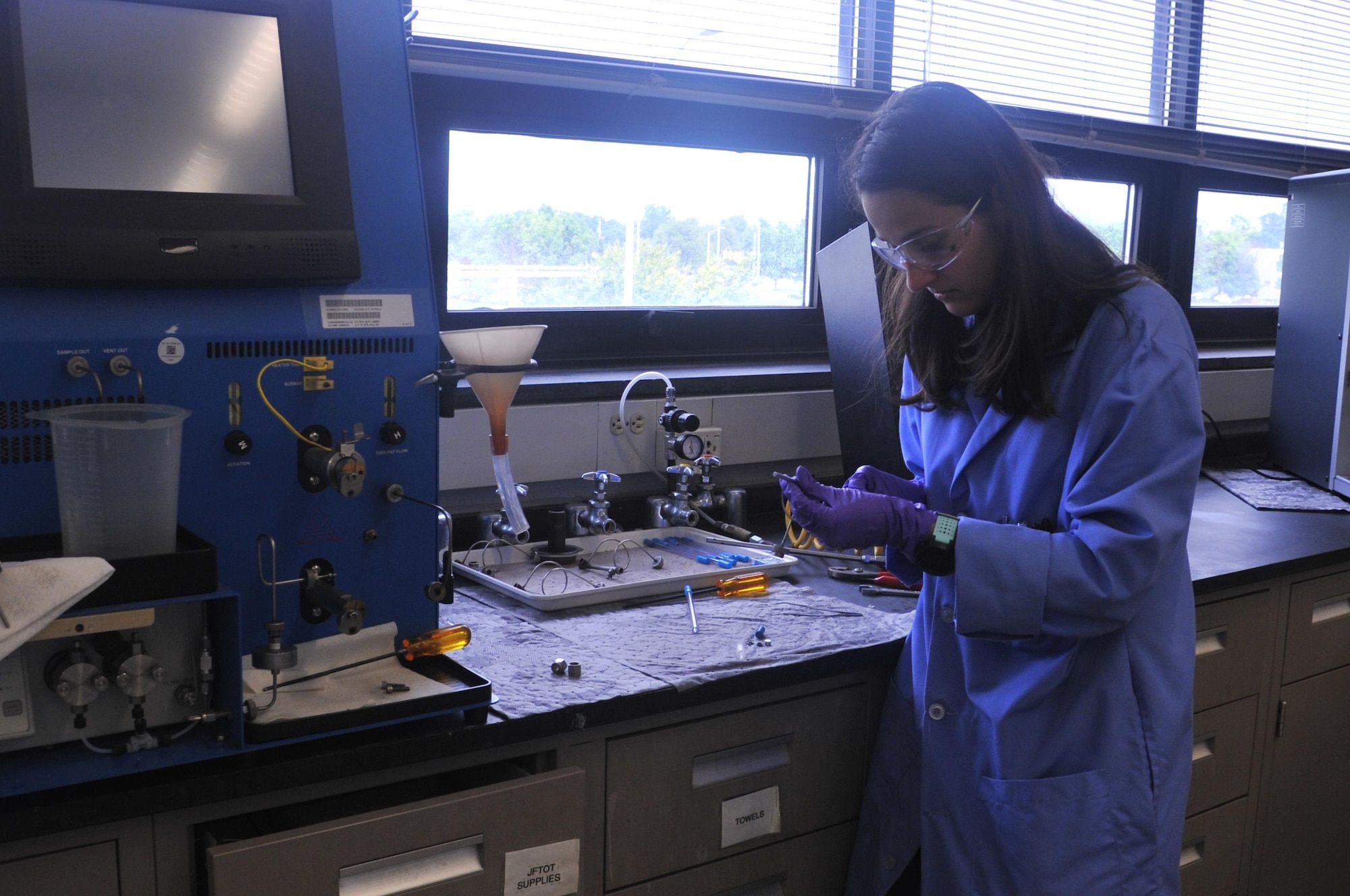 Zulmarie Jimenez, a chemist at the AFPET Fuels Lab, checks the thermal stability of a jet fuel. (U.S. Air Force photo/Sandy Simison)