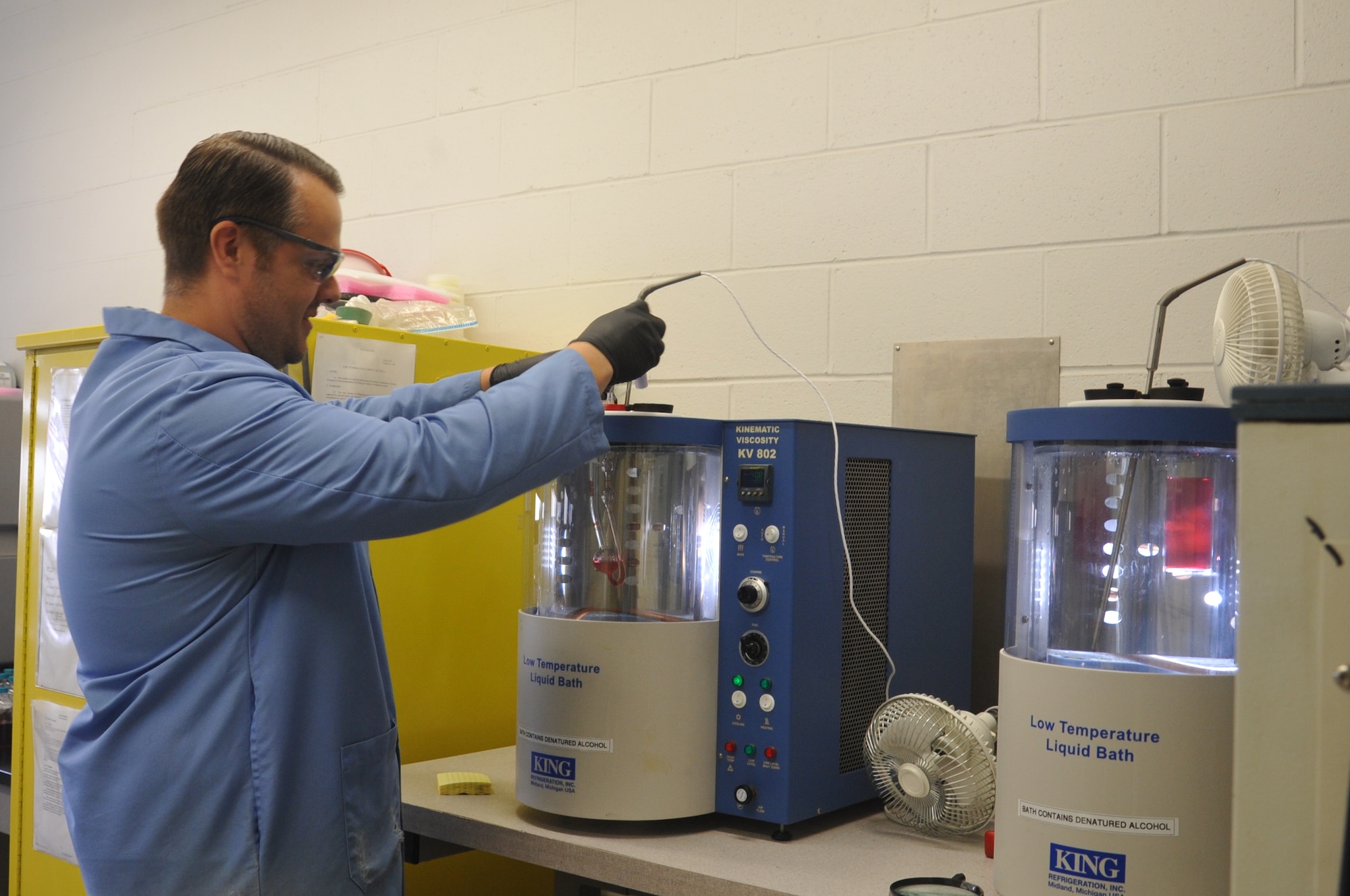 Jason King, Quality Assurance Specialist, AFPET Lube Lab, checks the viscosity of an aircraft hydraulic fluid. (U.S. Air Force photo/Sandy Simison)
