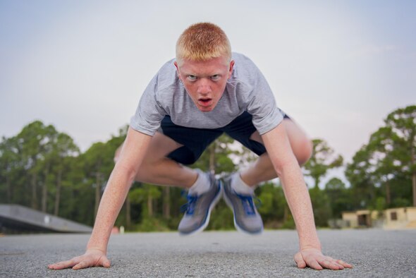 Junior Reserve Officers' Training Corps cadet Derrick Drennen performs a burpee during physical training at Hurlburt Field, Fla., July 20, 2016. From July 18-22, more than 60 Junior ROTC cadets from nearby high schools visited base for their Summer Leadership School - a course designed to teach cadets leadership, confidence and other traits. (U.S. Air Force photo by Airman 1st Class Joseph Pick)
