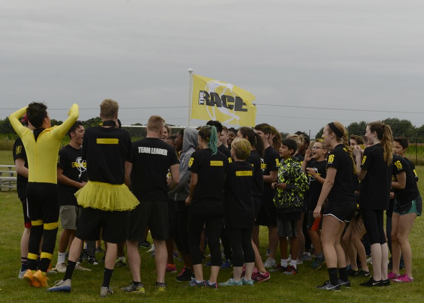 Yellow team participants chant before the ‘The RACE’ begins at Royal Air Force Lakenheath, England, Aug. 1, 2016. The RACE is a chapel-led program designed to help new students make friends before the start of the school year. (U.S. Air Force photo by Airman 1st Class Abby L. Finkel)