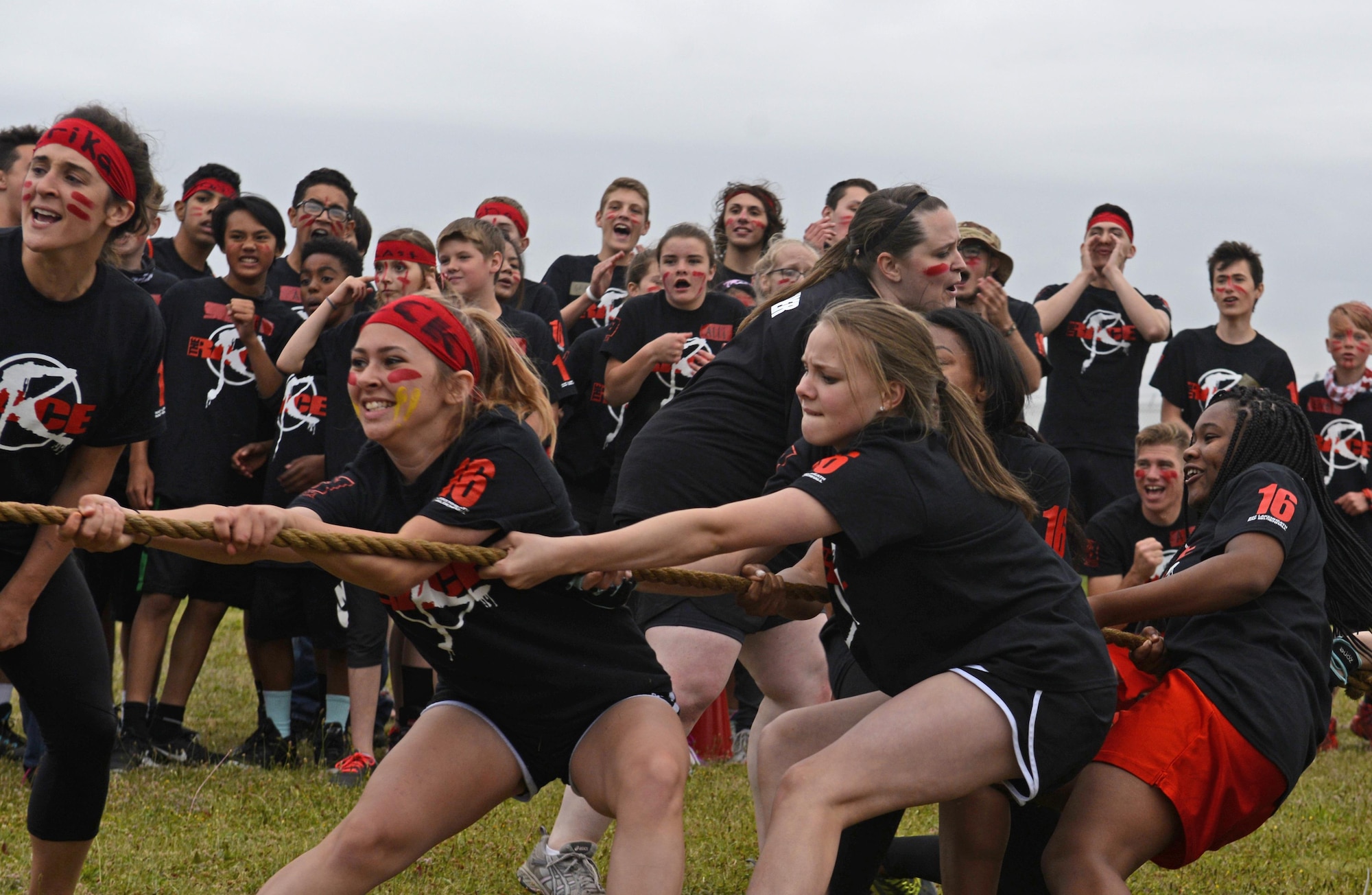 Girls from the red team participate in a game of tug-of-war during ‘The RACE’ at Royal Air Force Lakenheath, England, Aug. 1, 2016. Four teams competed against each other in a series of events created to build community among both new and returning middle and high school students. (U.S. Air Force photo by Airman 1st Class Abby L. Finkel)