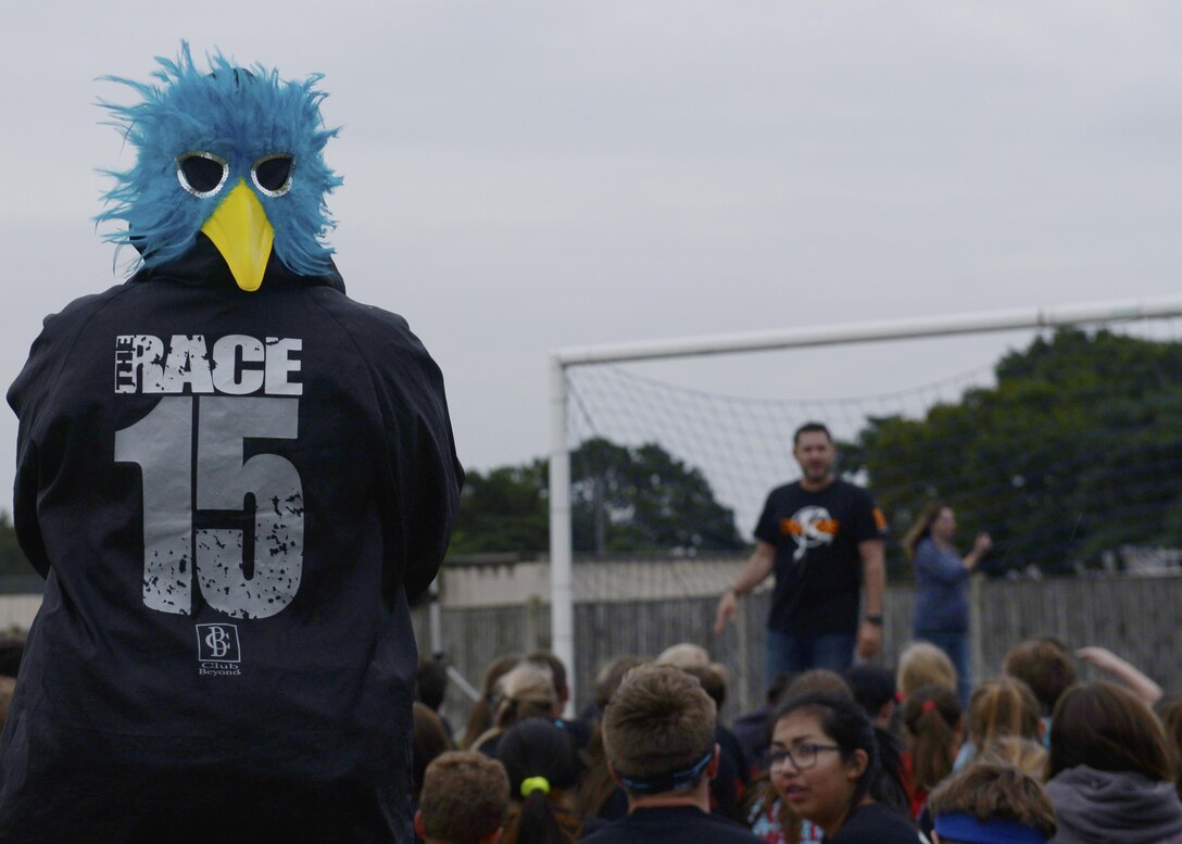 An event staff member watches the closing assembly during the first day of ‘The RACE’ at Royal Air Force Lakenheath, England, Aug. 1, 2016. ‘The RACE’ takes place every Monday evening in August to help incoming tri-base students adjust to their new surroundings and make friends before the start of the school year. (U.S. Air Force photo by Airman 1st Class Abby L. Finkel)