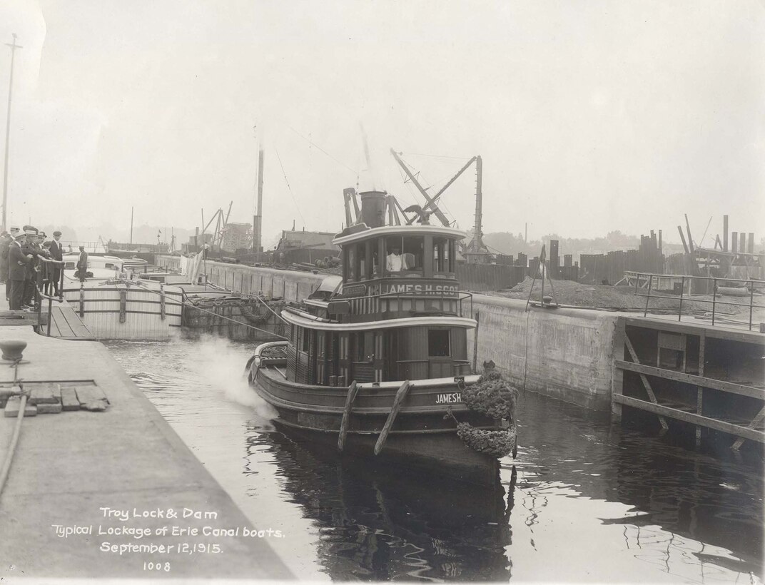 Historic image of a vessel traveling through the Troy Lock and Dam when it opened in 1915. 