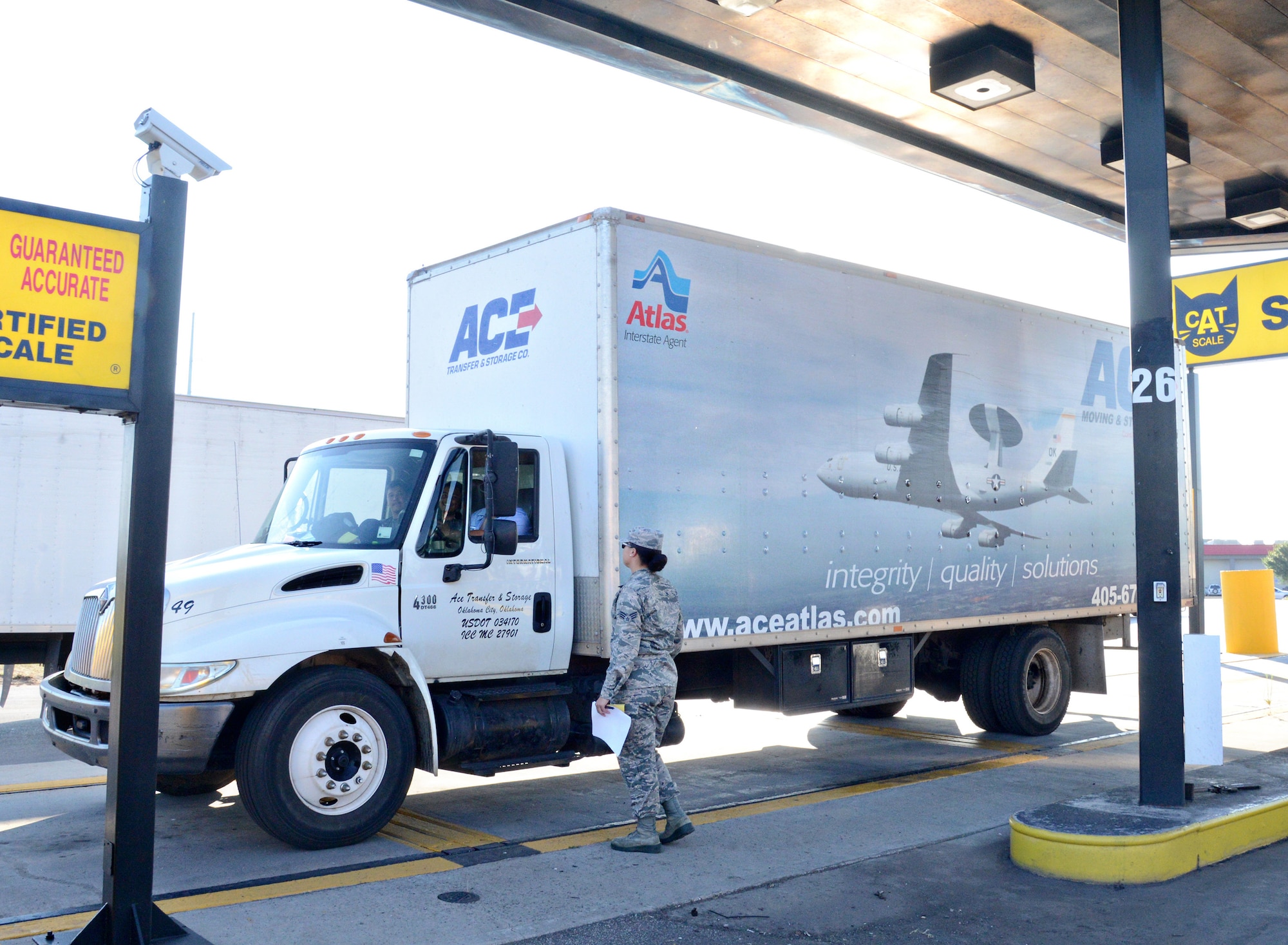 Senior Airman Brandie Benoit, with the 72nd Logistics Readiness Squadron, watches as a moving truck is re-weighed at a local weigh station. Inspectors with the Personal Property and Passenger Movement Section have saved over $800,000 by having moving companies re-weigh their vehicles and cargo and comparing it to the initial recorded weight. (Air Force photo by Kelly White)