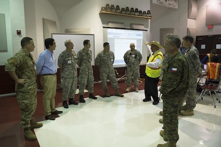 Eduardo Olivarez, Chief Administative Officer, Hidalgo County Department of Human Health Services (DHHS) and Texas State Guard leadership show leaders in the Chilean military the operations center at an Operation Lone Star (OLS) site in Pharr, Texas, July 27, 2016. The Texas Military Department, as a part of the State Partnership Program (SPP), partners with the Chilean military and conducts numerous exchanges each year facilitating cooperation across all aspects of international civil-military affairs and encouraging people-to-people ties at the state level. OLS is an annual medical disaster preparedness training exercise, uniting federal, state and local health and human service providers, that addresses the medical needs of thousands of underserved Texas residents every year. (U.S. Army National Guard photo by Sgt. 1st Class Malcolm McClendon)