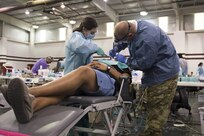 A U.S. Army Reserve dentist works alongside a civilian partner dental assistant to provide free dental services to a patient in need during an annual medical disaster preparedness exercise, July 27, 2016 in Pharr, Texas. Service members from the Texas State Guard worked alongside Soldiers from the 804th Medical Brigade, U.S. Army Reserves, the Texas Department of Public Safety, the Department of State Health Services, Remote Area Medical volunteers, Cameron County Department of Human Health Services (DHHS), City of Laredo Health Department, Hidalgo County DHHS and U.S. Public Health Services during Operation Lone Star (OLS), a week long real-time, large-scale emergency preparedness exercise in La Joya, Pharr, Brownsville, Rio Grande City and Laredo, Texas, July 25-29, 2016. OLS is an annual medical disaster preparedness training exercise, uniting federal, state and local health and human service providers, that addresses the medical needs of thousands of underserved Texas residents every year. (U.S. Army National Guard photo by Sgt. 1st Class Malcolm McClendon)