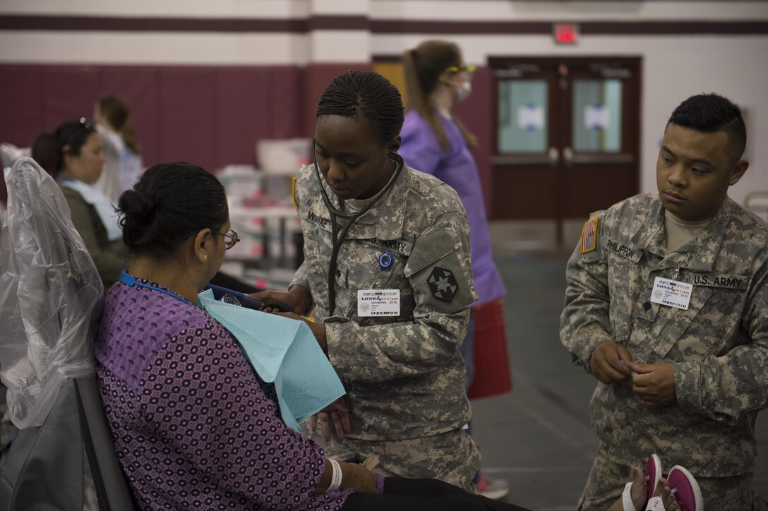 U.S. Army Reservists from the 804th Medical Brigade take blood pressure readings from a patient during an annual medical disaster preparedness exercise, July 27, 2016 in Pharr, Texas. Service members from the Texas State Guard worked alongside Soldiers from the 804th Medical Brigade, U.S. Army Reserves, the Texas Department of Public Safety, the Department of State Health Services, Remote Area Medical volunteers, Cameron County Department of Human Health Services (DHHS), City of Laredo Health Department, Hidalgo County DHHS and U.S. Public Health Services during Operation Lone Star (OLS), a week long real-time, large-scale emergency preparedness exercise in La Joya, Pharr, Brownsville, Rio Grande City and Laredo, Texas, July 25-29, 2016. OLS is an annual medical disaster preparedness training exercise, uniting federal, state and local health and human service providers, that addresses the medical needs of thousands of underserved Texas residents every year. (U.S. Army National Guard photo by Sgt. 1st Class Malcolm McClendon)