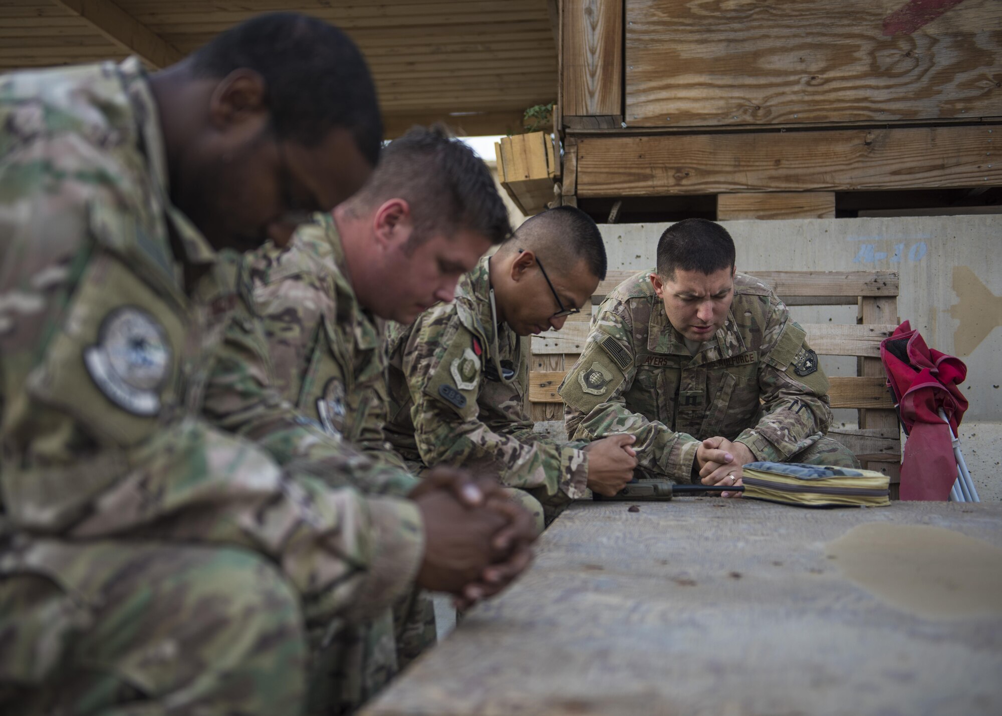 Capt. Jonathan Ayers, 455th Air Expeditionary Wing chaplain, prays with bible study attendees, Bagram Airfield, Afghanistan, Aug. 3, 2016. The chaplain team helps Bagram personnel remain spiritually resilient, by providing outlets such as religious ceremonies, a listening ear and activities that boost morale. They also provide advice to leadership regarding spiritual, religious, ethical and moral concerns. (U.S. Air Force photo by Senior Airman Justyn M. Freeman)
