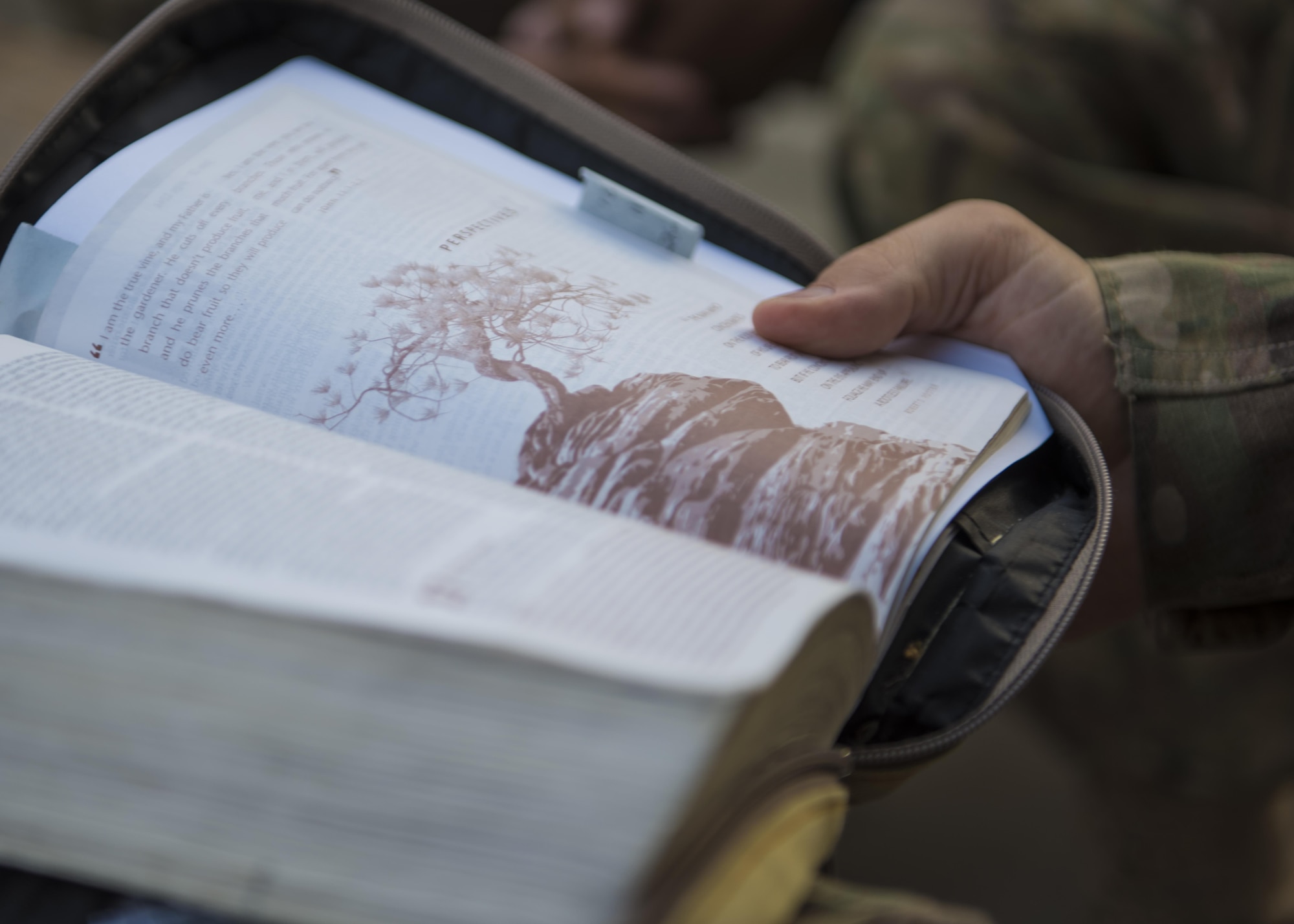 Capt. Jonathan Ayers, 455th Air Expeditionary Wing chaplain, reads a verse form the bible, Bagram Airfield, Afghanistan, Aug. 3, 2016. The chaplain team provides weekly bible study classes for Bagram personnel as a means to build and maintain spiritual resiliency. They support 10 units on the eastside of the base and also perform worship services and ceremonies for not only their own faith, but provides avenues to support other faiths. (U.S. Air Force photo by Senior Airman Justyn M. Freeman)
