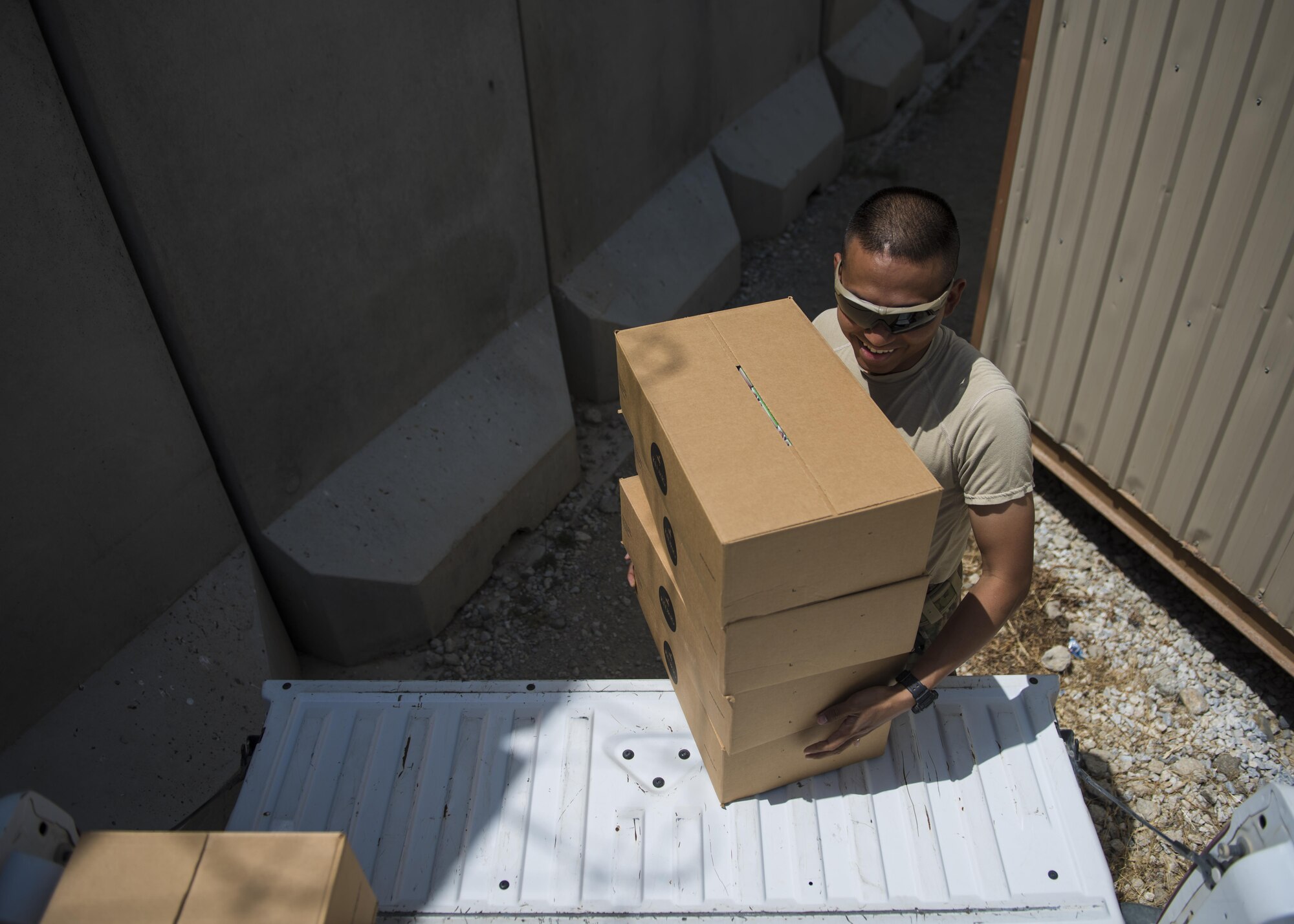 Staff Sgt. Chanreaksmey Sok, 455th Air Expeditionary Wing, chaplain’s assistant, loads coffee boxes, Bagram Airfield, Afghanistan, Aug. 4, 2016. As a way to boost morale and get to know the personnel better, the chaplain team often delivers donated coffee to units around the base. (U.S. Air Force photo by Senior Airman Justyn M. Freeman)