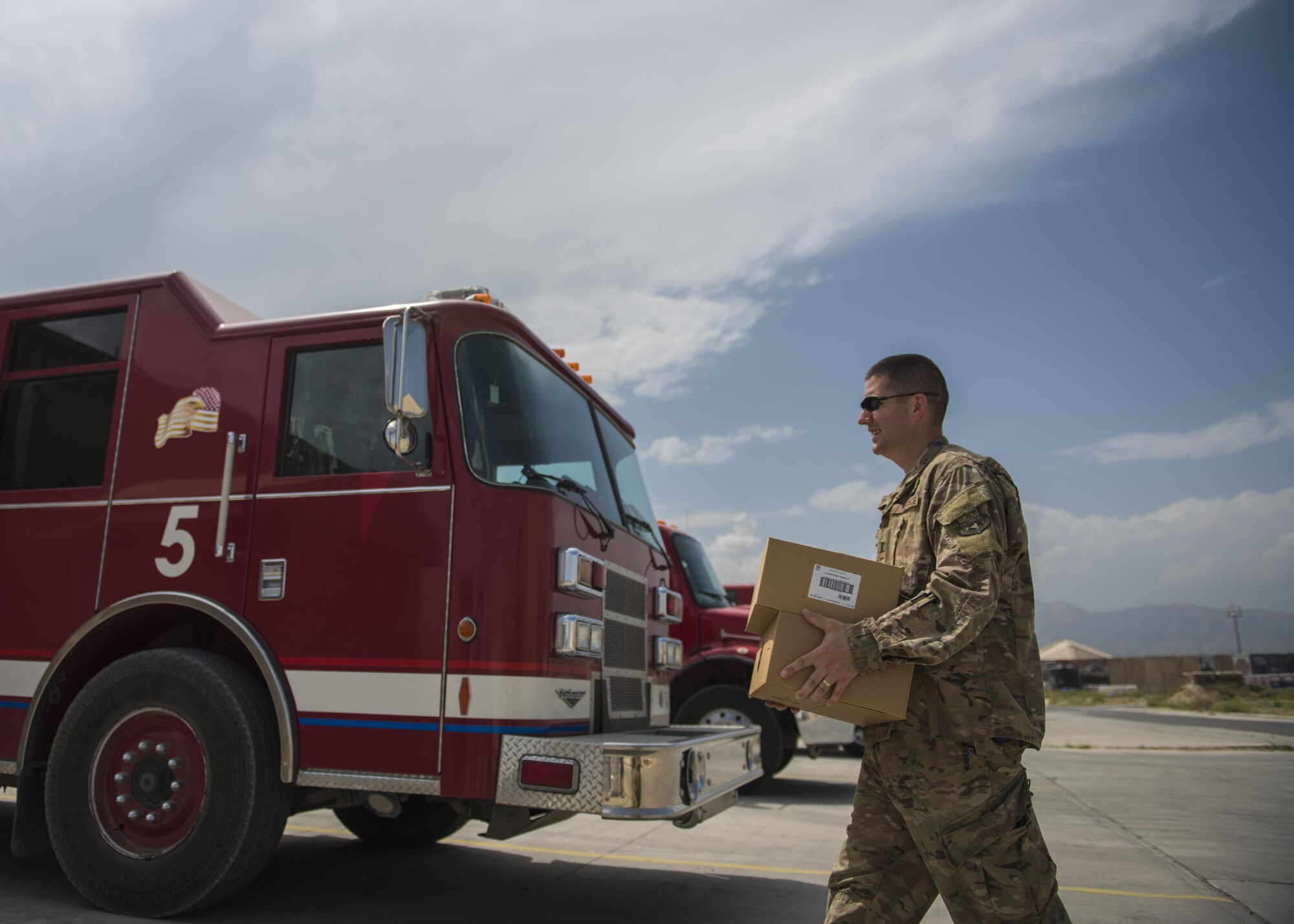 Capt. Jonathan Ayers, 455th Air Expeditionary Wing chaplain, carries boxes of coffee to deliver to the Fire Department, Bagram Airfield, Afghanistan, Aug. 4, 2016. The chaplain team supports 10 units on the east side of the base. Delivering coffee is a way to boost morale and get a chance to engage with unit members. (U.S. Air Force photo by Senior Airman Justyn M. Freeman)