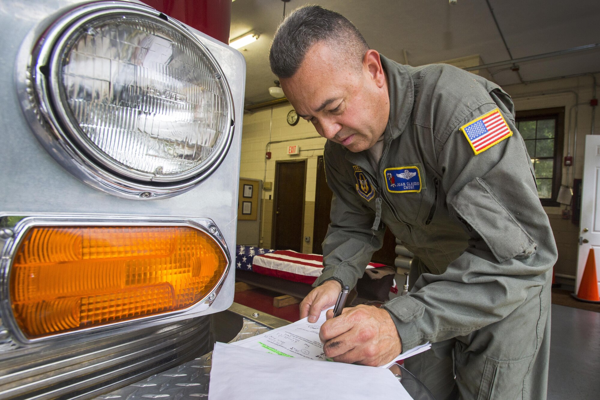 Chief Master Sgt. Juan Claudio, a loadmaster with the 514th Air Mobility Wing, Air Force Reserve, writes the final measurements for a 1982 Mack 1250 GPM pumper fire truck at Mercer Engine No. 3 fire department in Princeton, N.J., July 13, 2016. The fire truck is being donated to a group of volunteer firefighters in Managua, Nicaragua through the Denton Program, which allows U.S. citizens and organizations to use space available on military cargo aircraft to transport humanitarian goods to countries in need. (U.S. Air National Guard photo by Master Sgt. Mark C. Olsen/Released)
