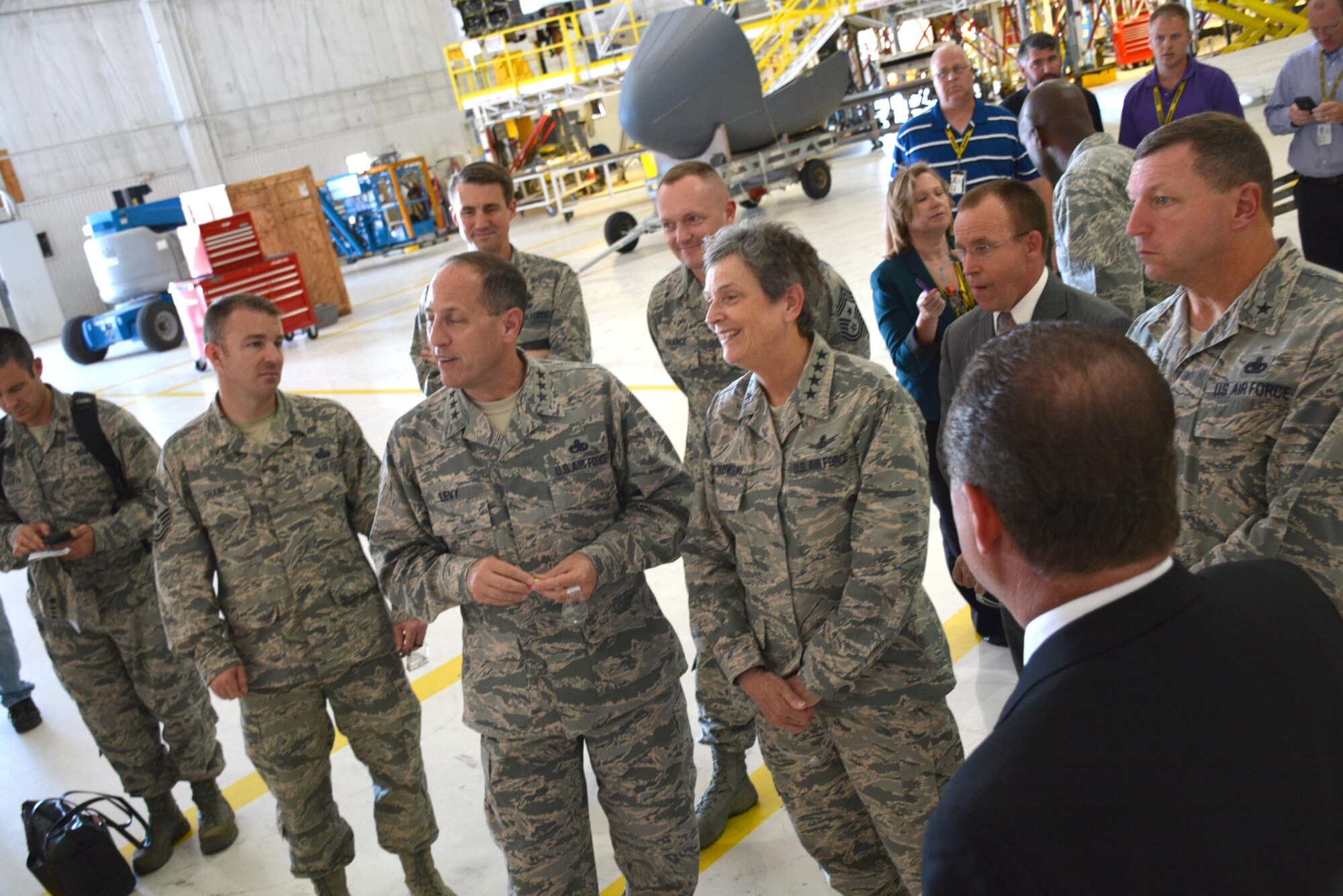 Lt. Gen. Lee K. Levy II, Air Force Sustainment Center commander, second from left, and Gen. Ellen Pawlikowski, commander, Air Force Materiel Command, share a light moment while discussing the challenges associated with the aging B-52 aircraft during a visit to Bldg. 2121 on July 18. The stop in Bldg. 2121 was just one of many General Pawlikowski and AFMC Command Chief Master Sgt. Jason France made on their visit to Tinker Air Force Base.