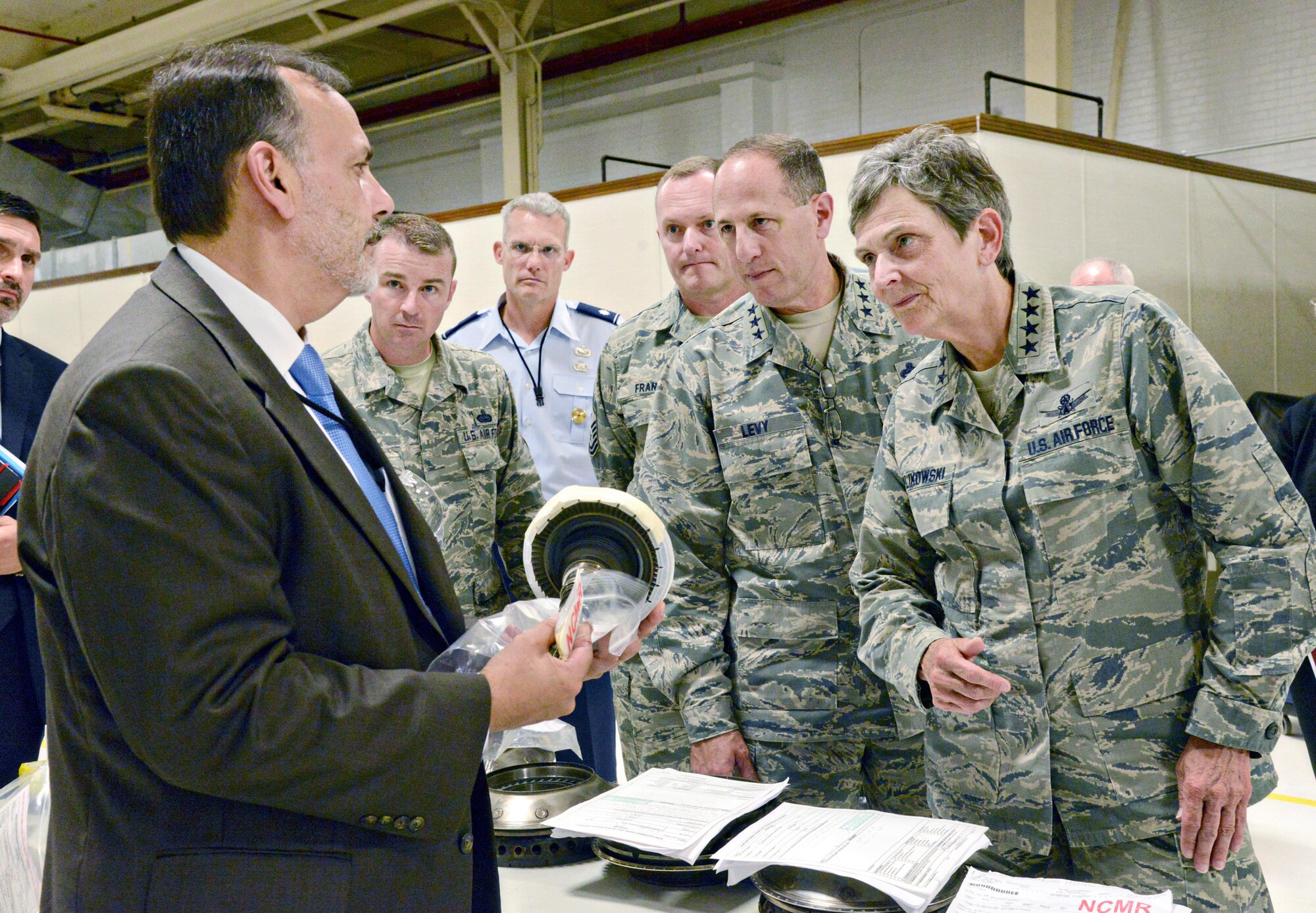 Ralph Garcia, Air Force Life Cycle Management Center director of Propulsion, discusses F107 engine production challenges with Air Force Materiel Command Commander Gen. Ellen Pawlikowski during her visit to Tinker AFB July 18.