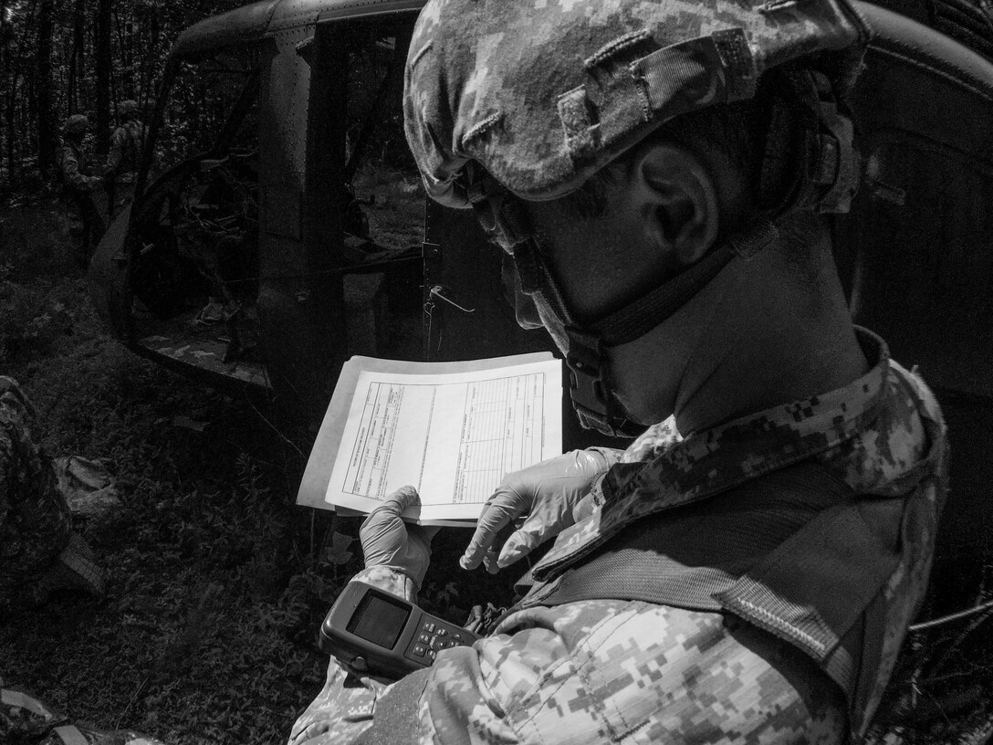 A U.S. Army Reserve soldier with the 246th Quartermaster Company (Mortuary Affairs), Mayaguez, Puerto Rico, pulls GPS coordinates for a search and recovery report at a simulated helicopter crash during Mortuary Affairs Exercise 16-02, July 21, at Fort Pickett, Va. MAX 16-02 included all six U.S. Army Reserve Mortuary Affairs units performing search and recovery missions and operating Mortuary Affairs Collection Points and a Theater Mortuary Evacuation Point. The units were evaluated by active-duty mortuary affairs personnel from nearby Fort Lee, Va. (U.S. Army photo by Timothy L. Hale)(Released)