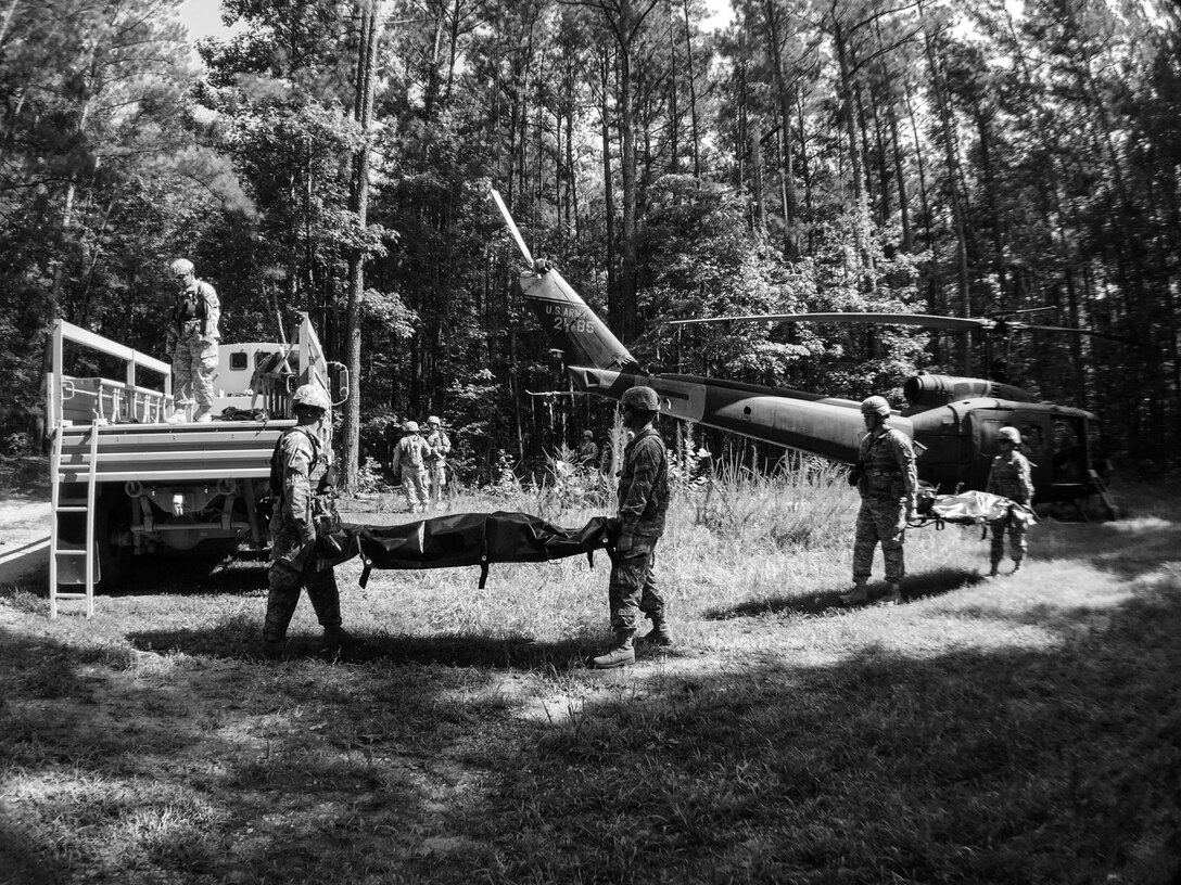 U.S. Army Reserve soldiers with the 246th Quartermaster Company (Mortuary Affairs), Mayaguez, Puerto Rico, remove the simulated human remains from a simulated helicopter crash during Mortuary Affairs Exercise 16-02, July 21, at Fort Pickett, Va. MAX 16-02 included all six U.S. Army Reserve Mortuary Affairs units performing search and recovery missions and operating Mortuary Affairs Collection Points and a Theater Mortuary Evacuation Point. The units were evaluated by active-duty mortuary affairs personnel from nearby Fort Lee, Va. (U.S. Army photo by Timothy L. Hale)(Released)